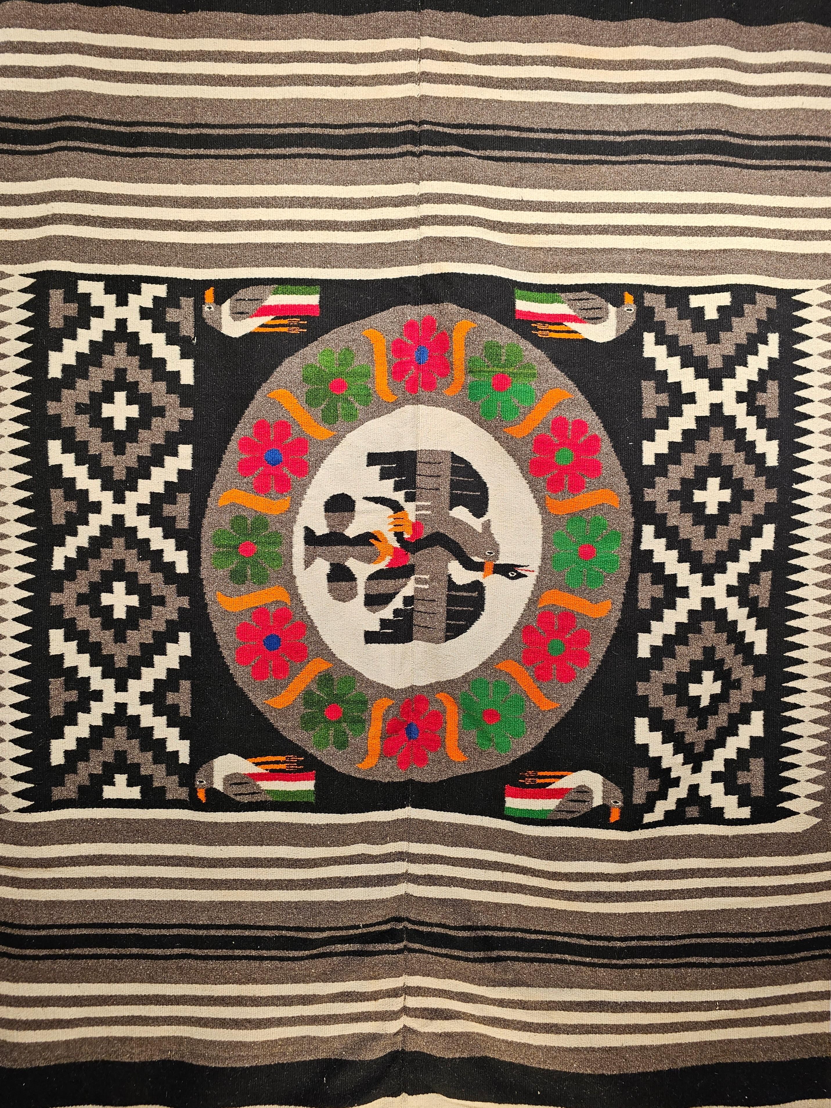 Vintage Mexican Serape Kilim Rug in Gray, Black and Ivory Colors. A beautiful Serape kilim rug was woven in Mexico in the 4th quarter of the 1900s and has a unique and colorful Mexican Flag design in the center. The kilim is made of two individual