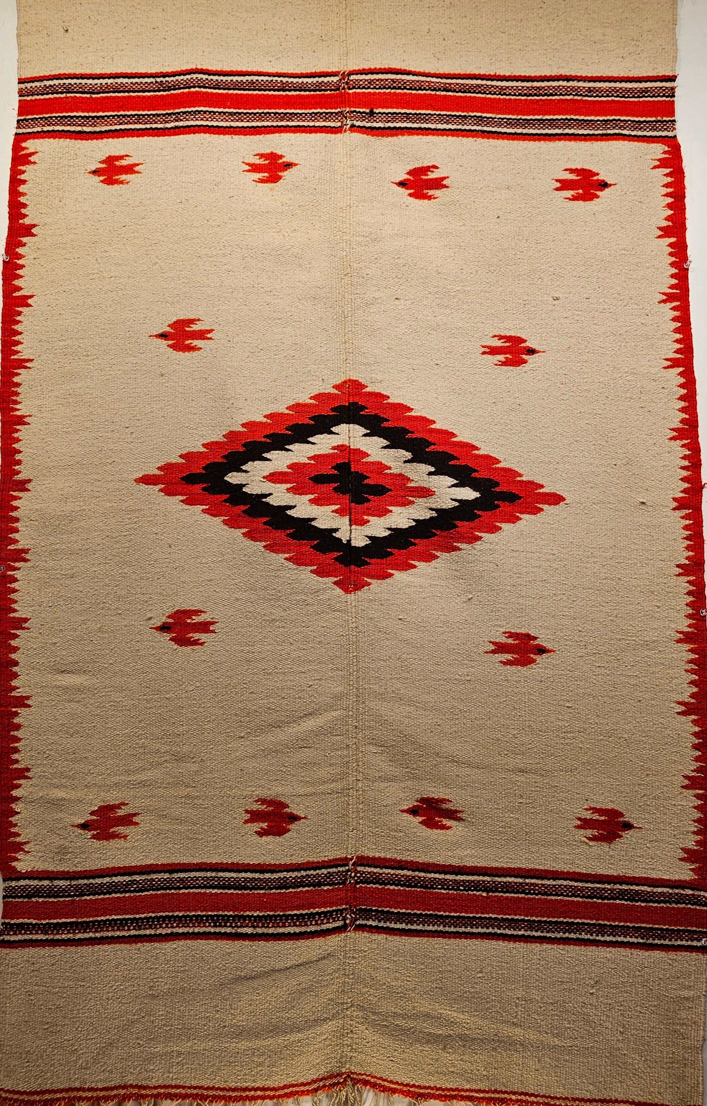 Vintage Mexican Serape Saltillo Kilim Rug in cream color. A beautiful Serape kilim blanket rug was woven in Mexico in the late 20th century. The rug has a beautiful cream or wheat colored wool with designs of birds in vibrant orange. It has a