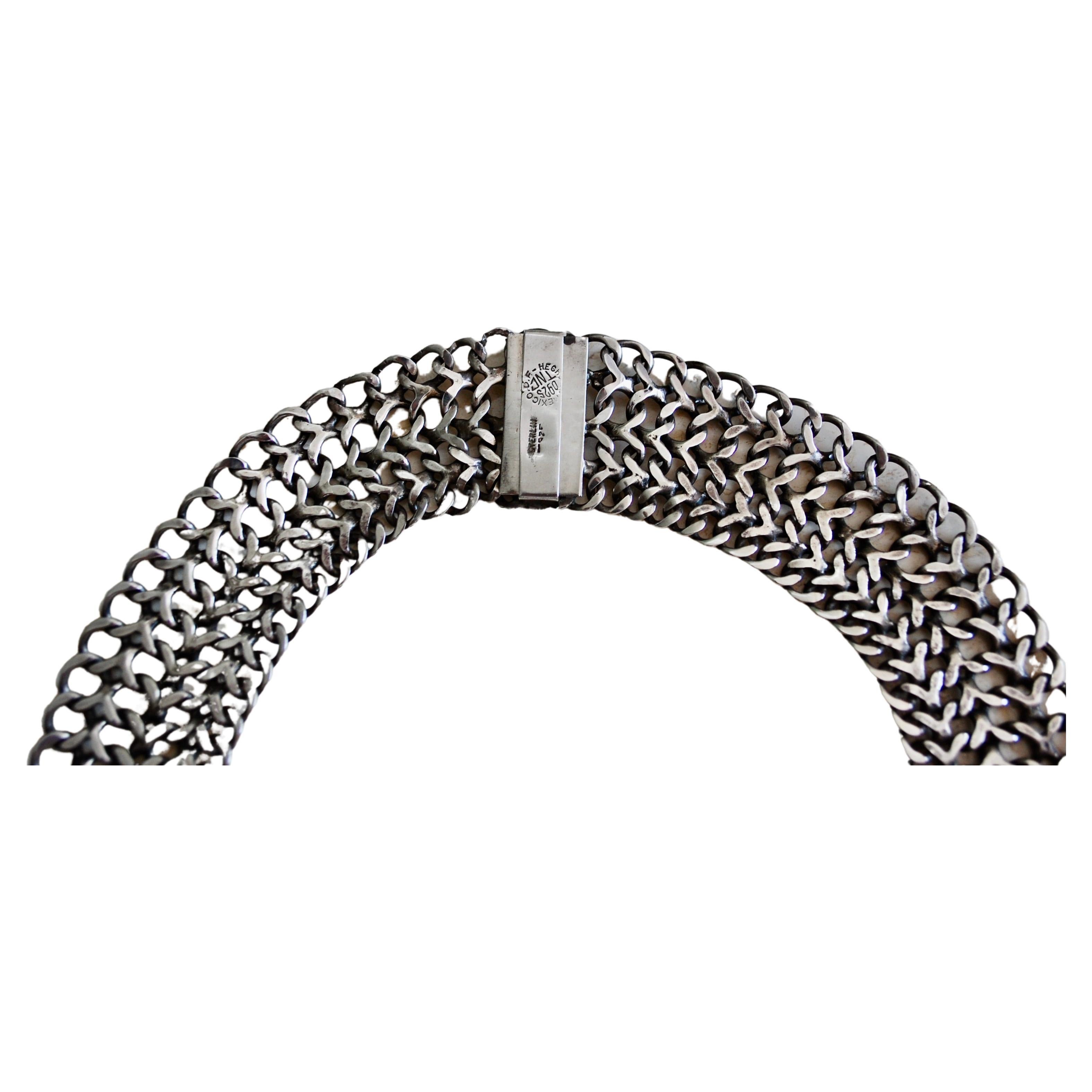 This is a vintage handmade TAXCO sterling silver choker necklace.  It is handmade and in Excellent Vintage Condition. It weighs about 105 grams.
It is 17 inches long little over 1 inch wide.  It has a slide in lock closure. A truly a statement and