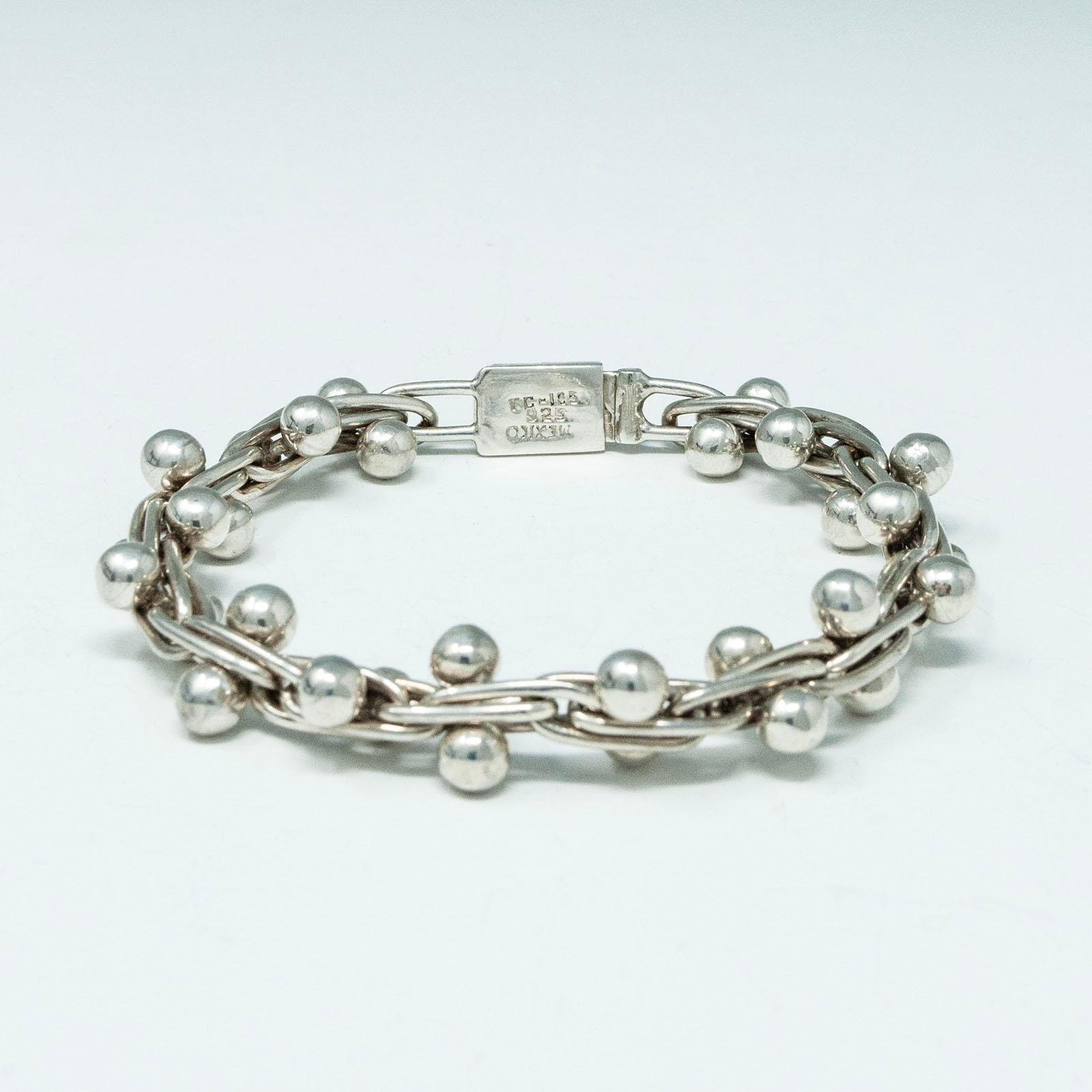 Vintage Mexican Sterling Silver Panel Bracelet 

A handsome version of the Spratling peppercorn link bracelet made in Mexico. It measures 9 inches flat with an inner circumference, when closed, of 7.25 inches. The weight is 42 grams and it is marked