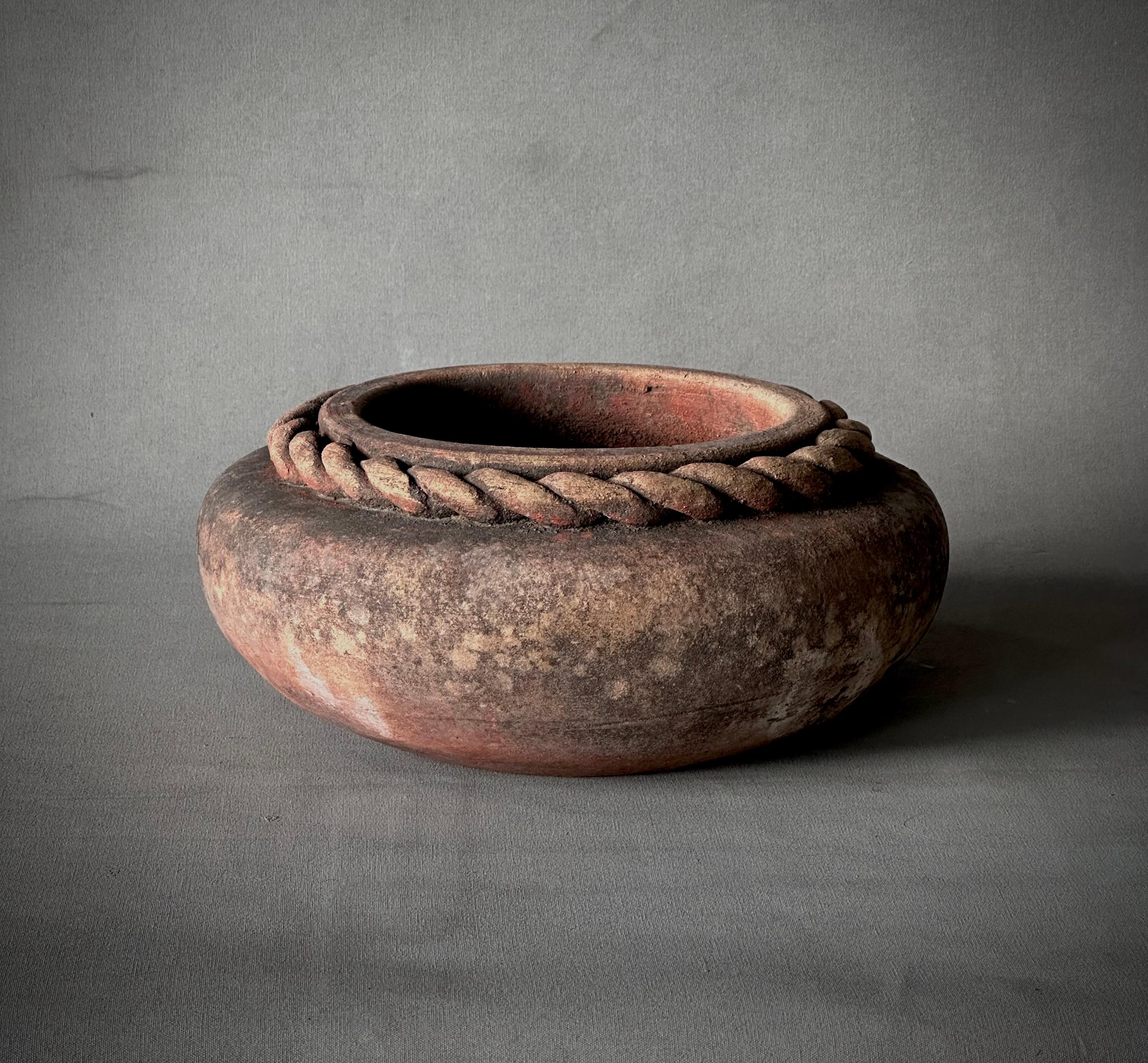 Decorative terracotta vessel from Jalisco, Mexico with unique carved rope banding at rim and wide, shallow shape. Perfect as a planter or rustic and sculptural decorative accent. 

