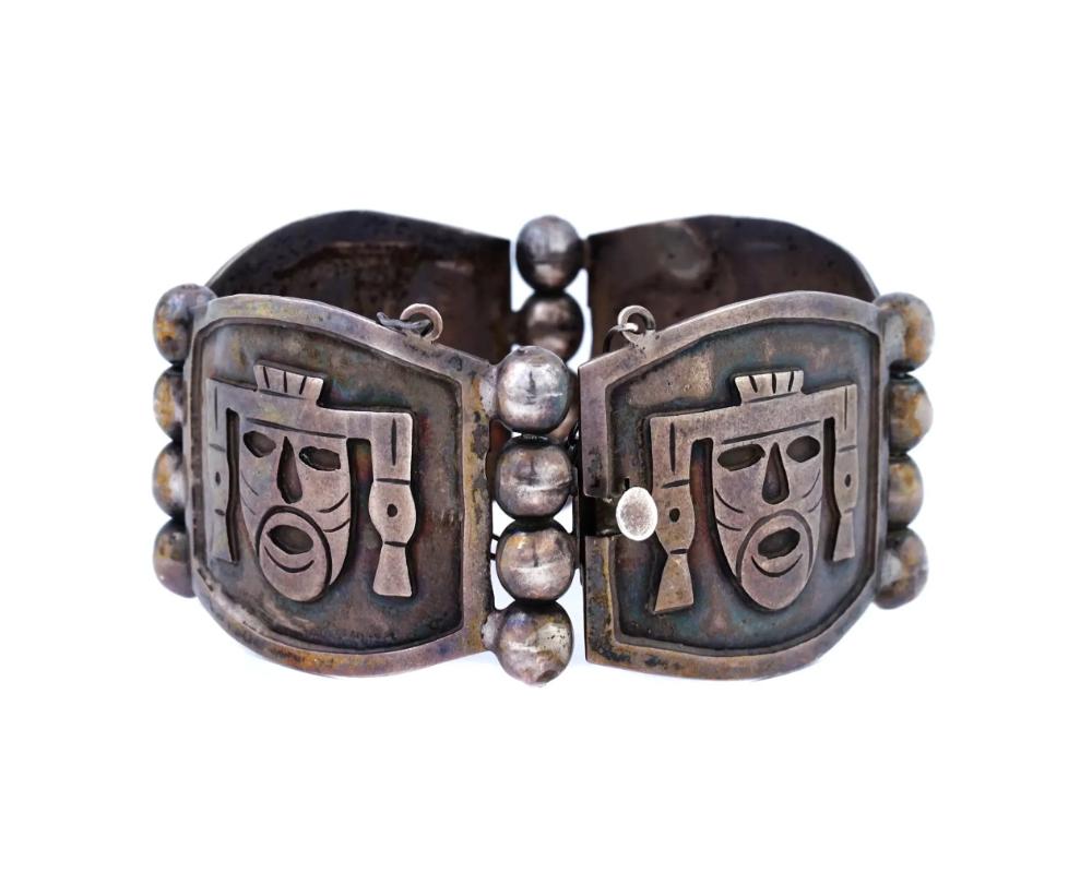 A vintage Mexican sterling silver link bracelet with a safety chain. The links are decorated with relief Aztec masks. Marked Mexico 925 by the clasp. Total Weight: 34 grams. 

OVERALL GOOD VINTAGE CONDITION. SIGNS OF AGE AND WEAR. REFER TO