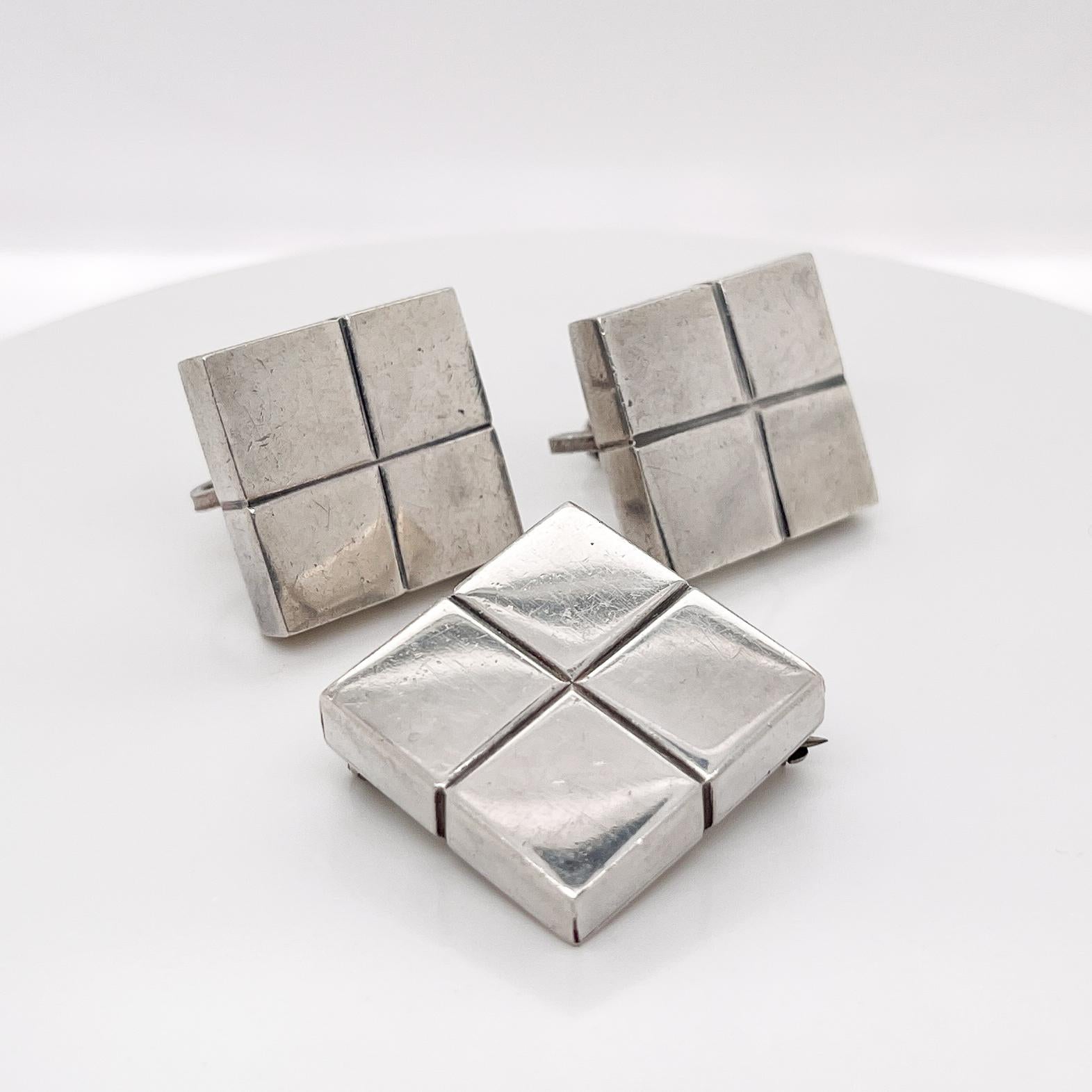 A very fine, three-piece Mexican silver modernist square cube clip-on earrings  and brooch.

By William Spratling. 

With cube-shaped screw back earrings with screwbacks and a conformning cube-shaped brooch.   

Simply a terrific parure from on of
