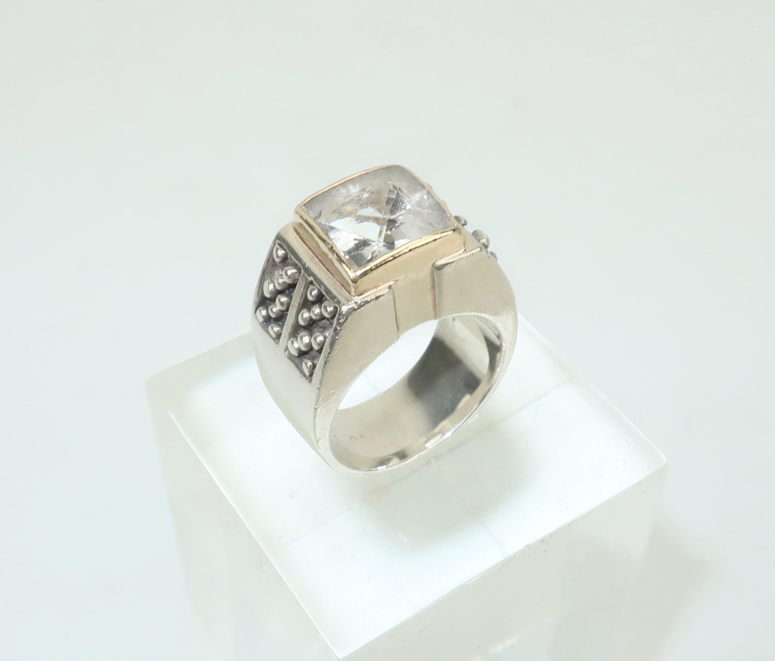 A fabulous ring always gets noticed!  This modernist beauty by Michael Dawkins is a real stand out.  The bold sterling silver silhouette is decorated with Dawkins iconic ‘beading’ which flanks a square faceted quartz crystal framed in 14K gold. 