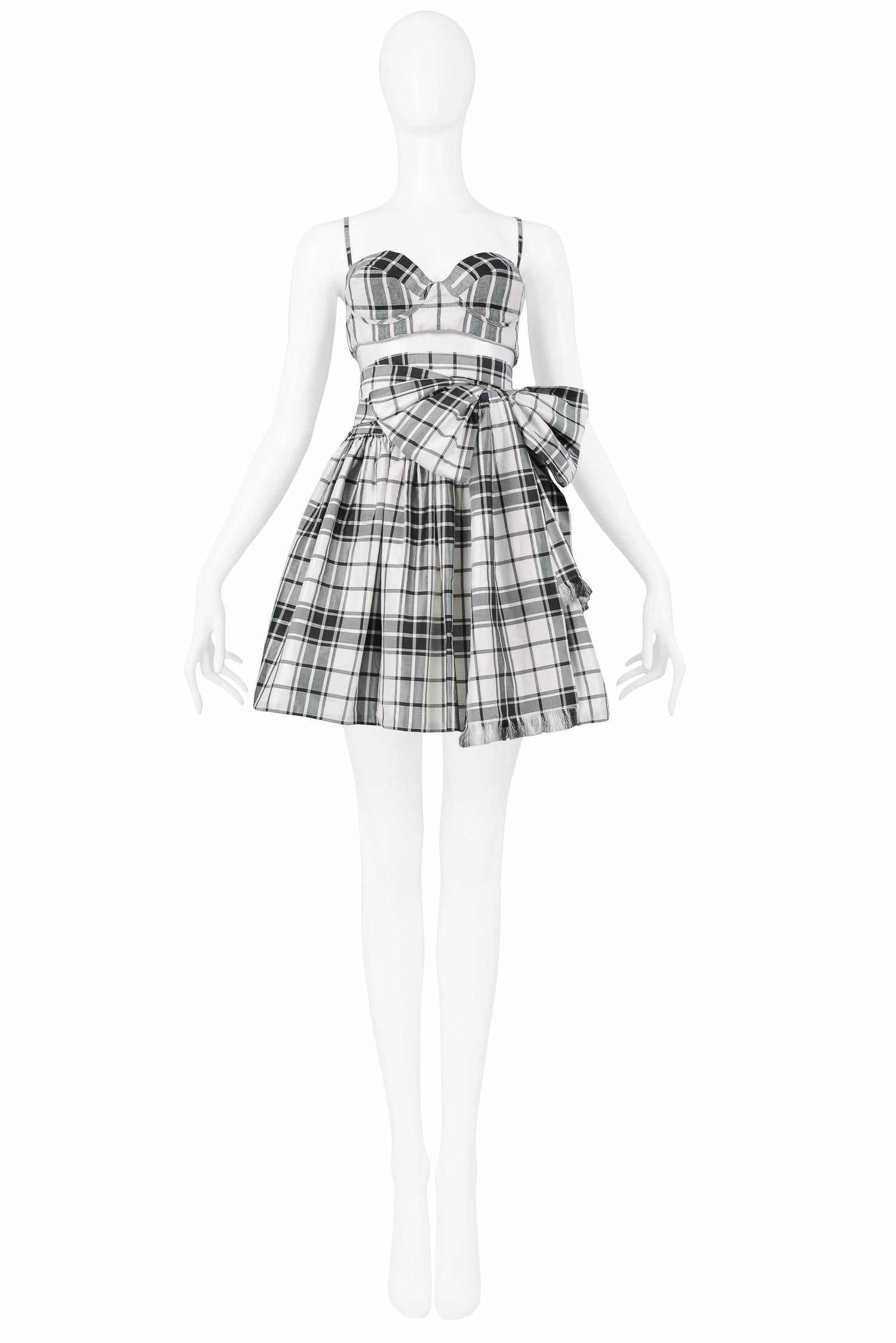 Vintage Michael Kors black & white plaid ensemble with bustier crop top and matching full mini skirt with attached wrap tie that ties in the front or back. 1992 Spring/Summer Collection.

Excellent Vintage Condition.

Size
Top: Small
Skirt: Medium