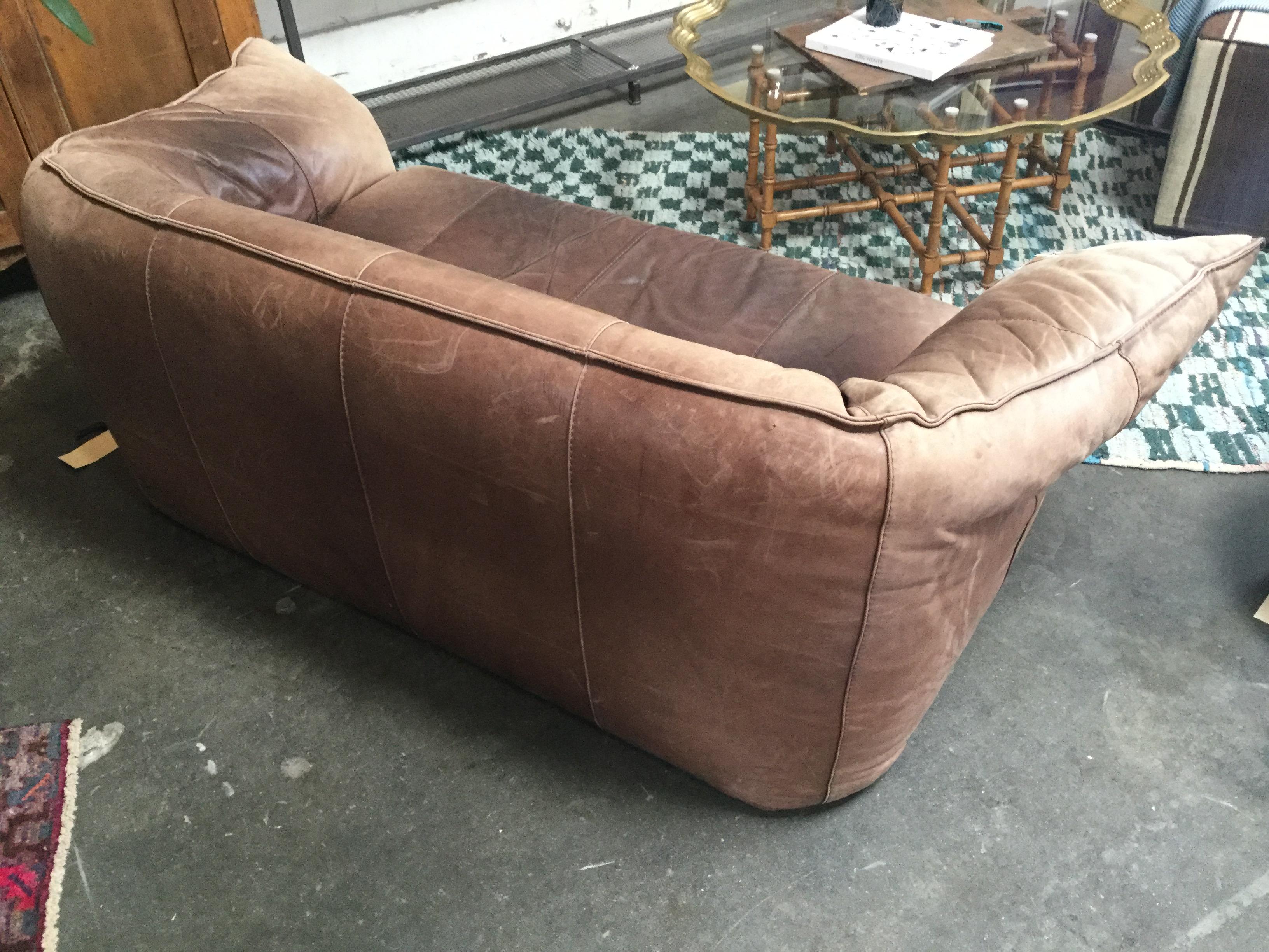 French 1960s leather Michel Ducaroy styled handmade sofa. With a rich mocha color and aged leather. Styled in the idea of 1960s lounge.