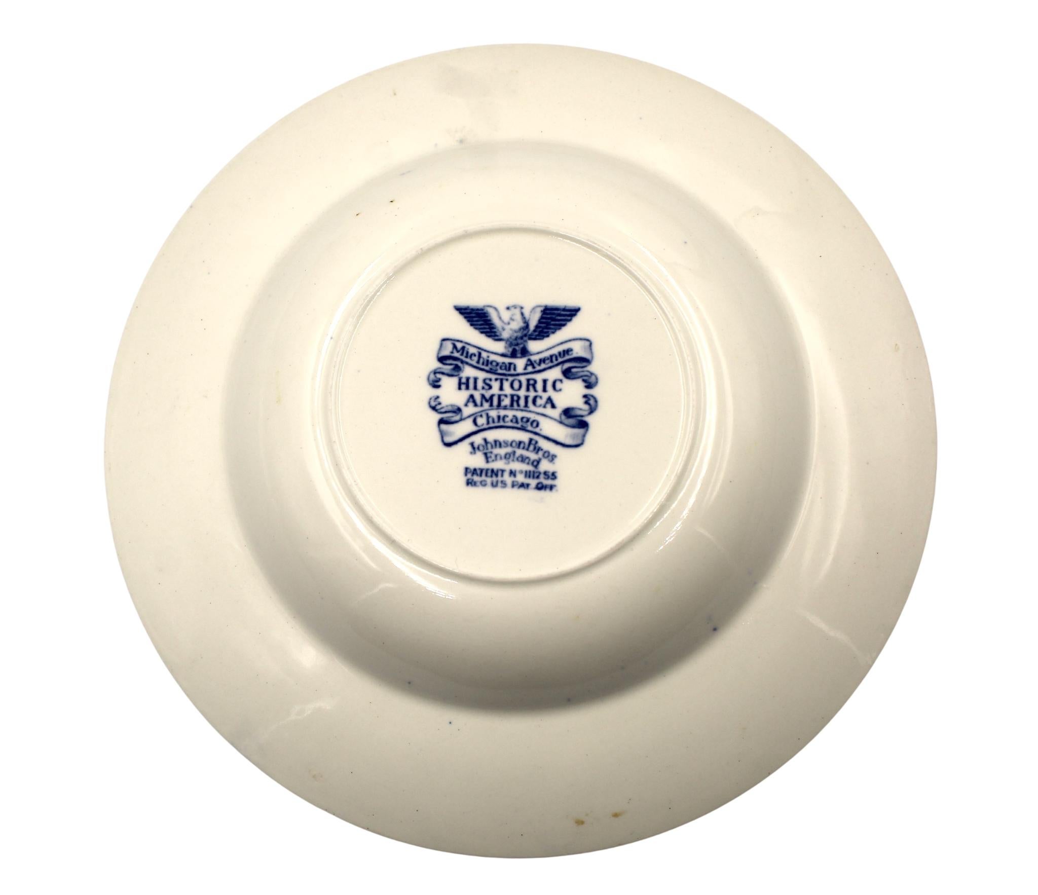 Presented is a blue-glazed transferware plate, by the famous British potters Johnson Brothers. Made in England, this plate comes from their “Historic America” line of ceramics, with the specific pattern celebrating the iconic Michigan Avenue in