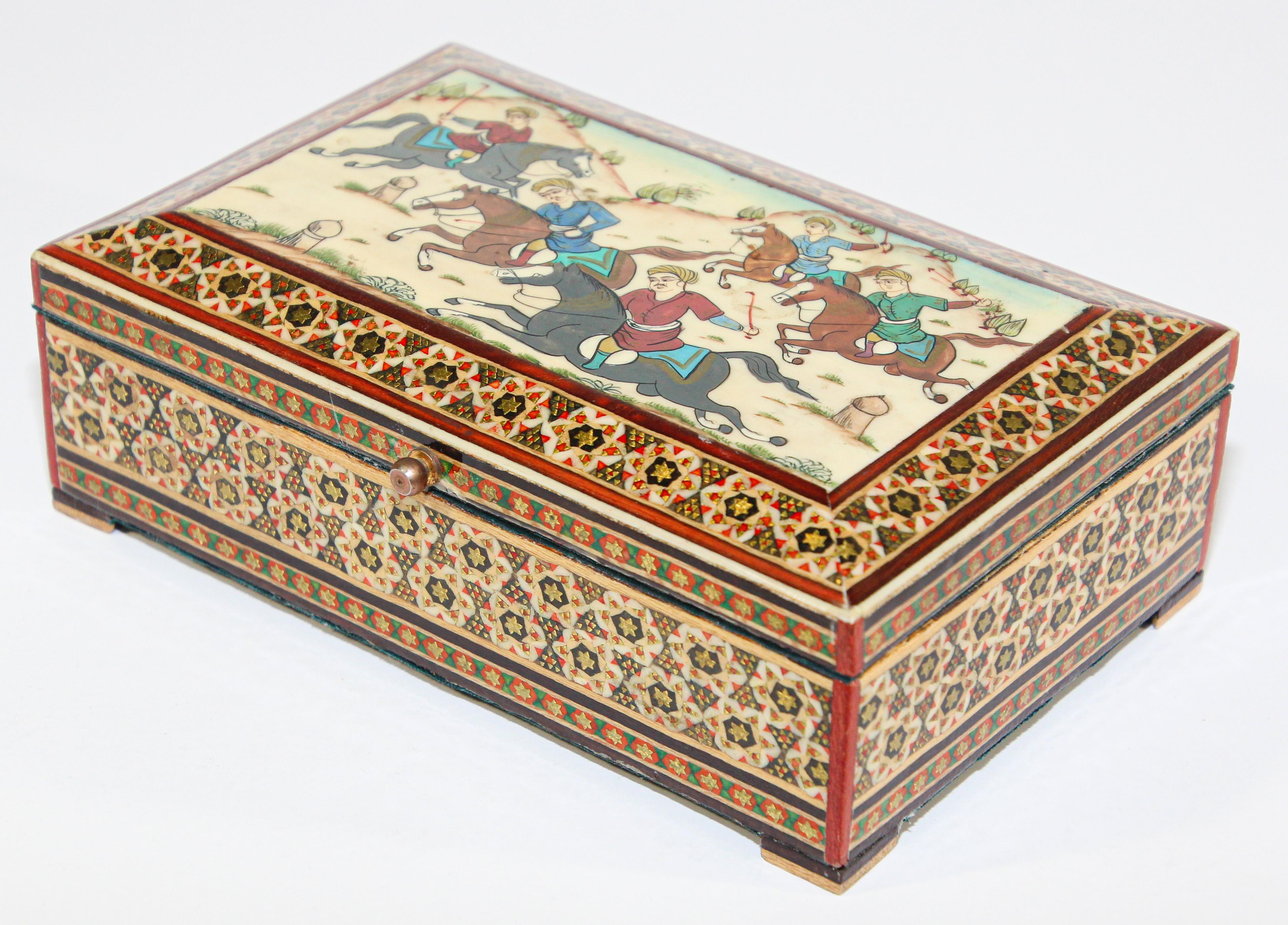 Handcrafted vintage marquetry Indo Persian wood inlay micro mosaic with miniature hand painted scene.
Finely handcrafted khatam wooden box with very delicate micro mosaic marquetry from the ancient Persian technique of inlaying from arrangements of