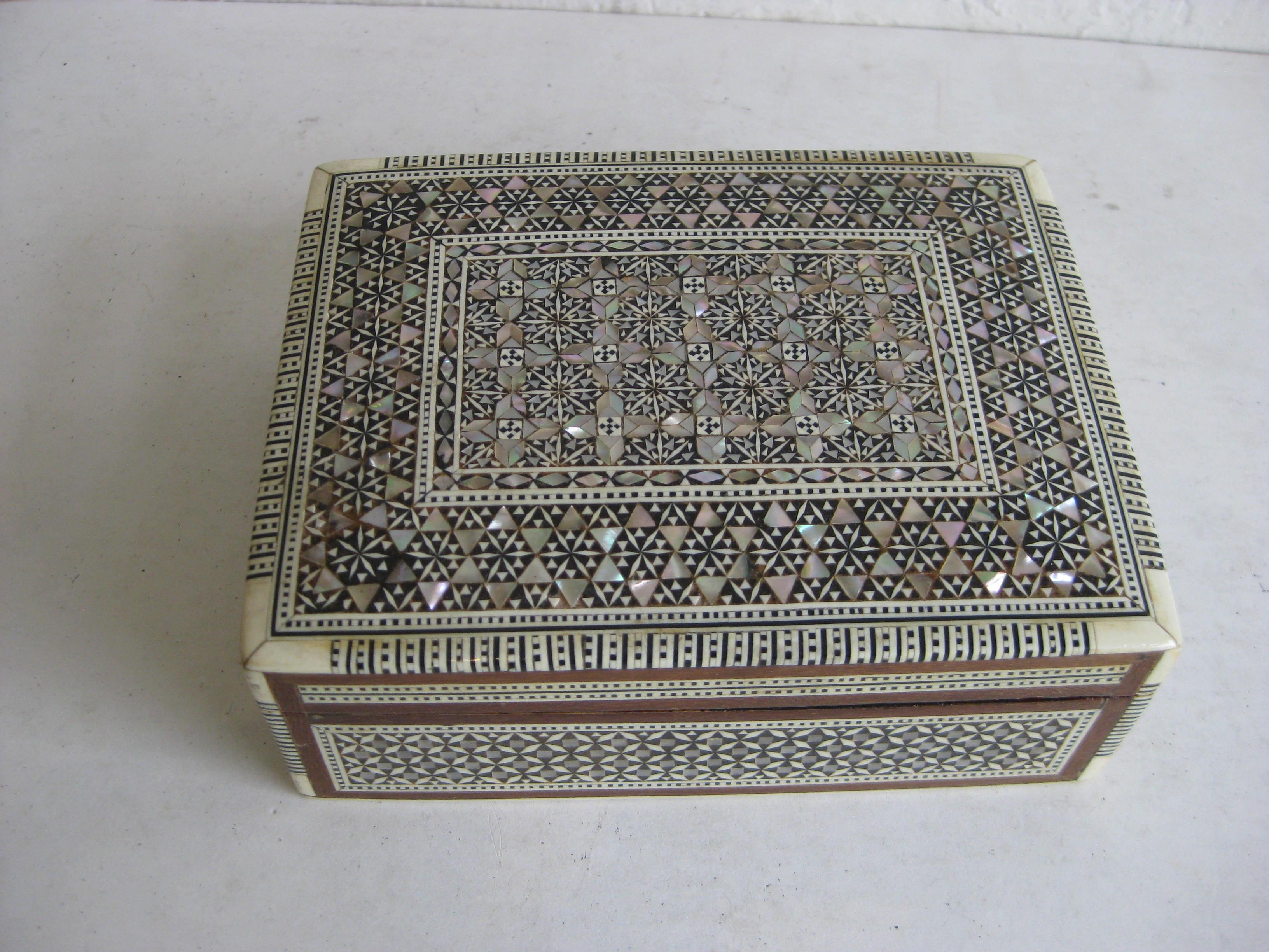 Beautiful highly detailed handcrafted micro mosaic marquetry wooden trinket/jewelry box. Pieces are made of mother of pearl and bone. High quality wood work and made very well. Inside is lined with red velvet. Measures approx. 6 1/4