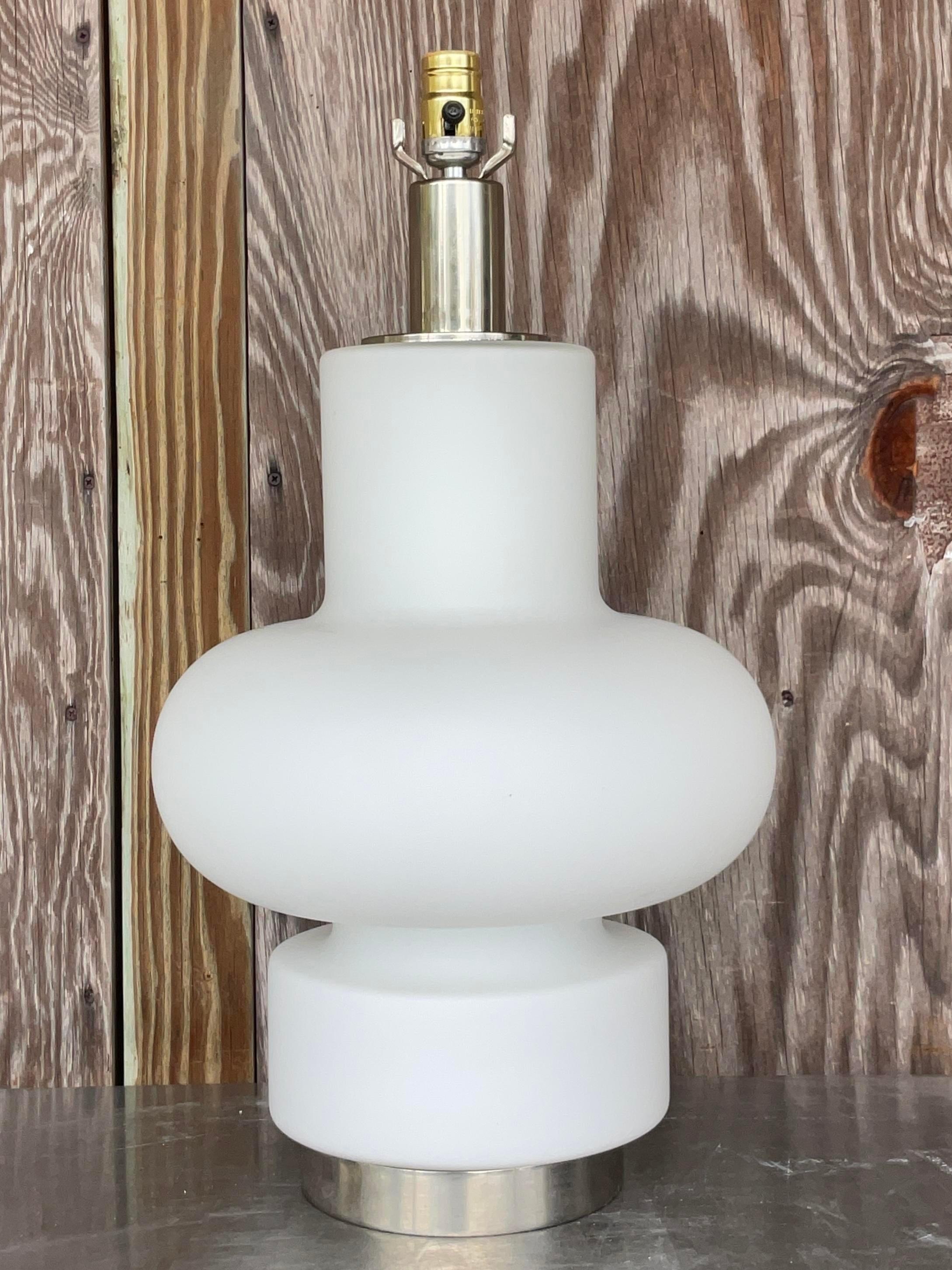 Vintage MCM Bobo Piccoli For Fontana Arte Glass Lamp epitomizes the iconic design ethos of mid-century America. Crafted with exquisite attention to detail, this lamp radiates elegance and sophistication, offering a timeless statement piece for any