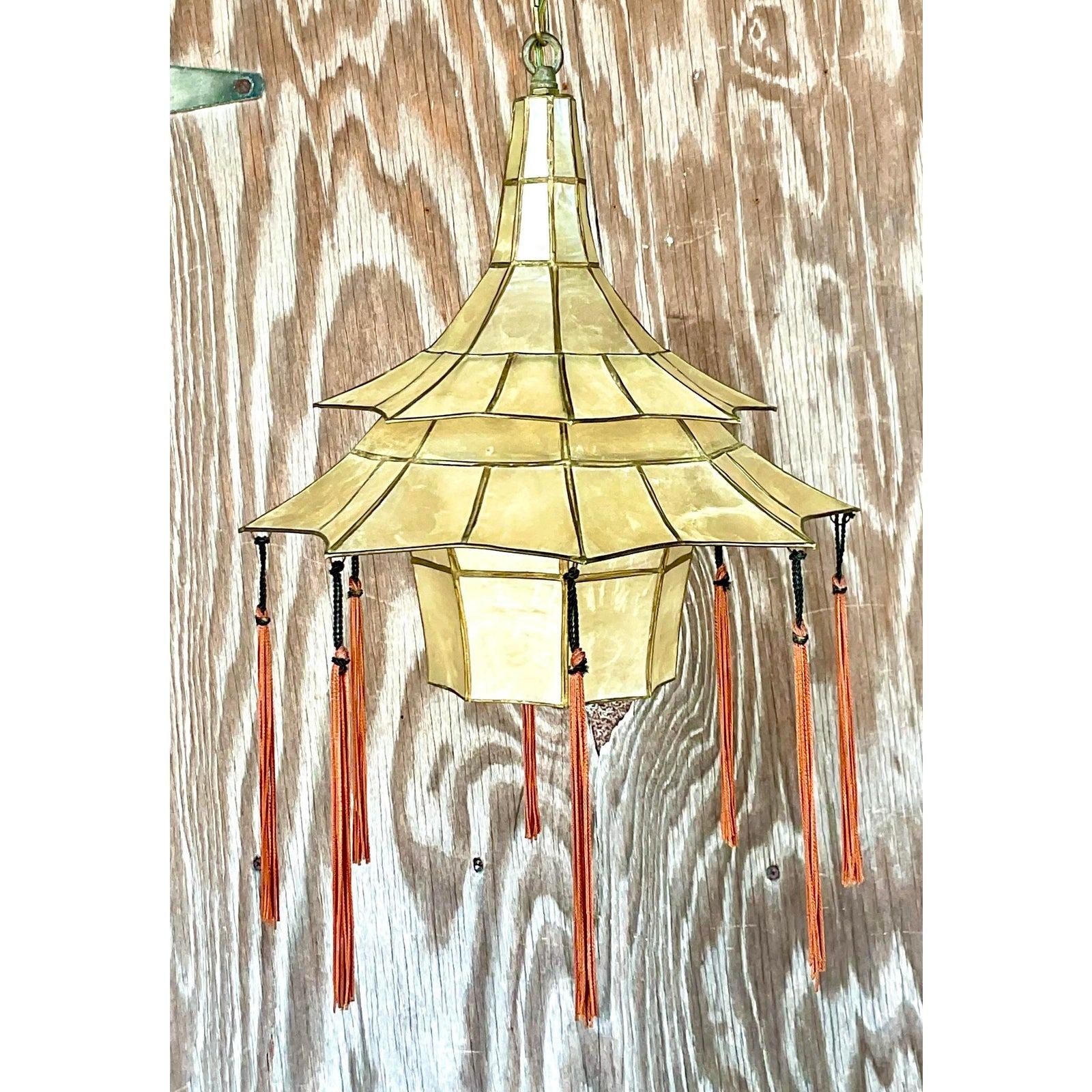 A spectacular vintage Boho chandelier. A beautiful Capiz shell construction in a chic Pagoda shape. Original hanging tassels. Acquired from a Palm Beach estate