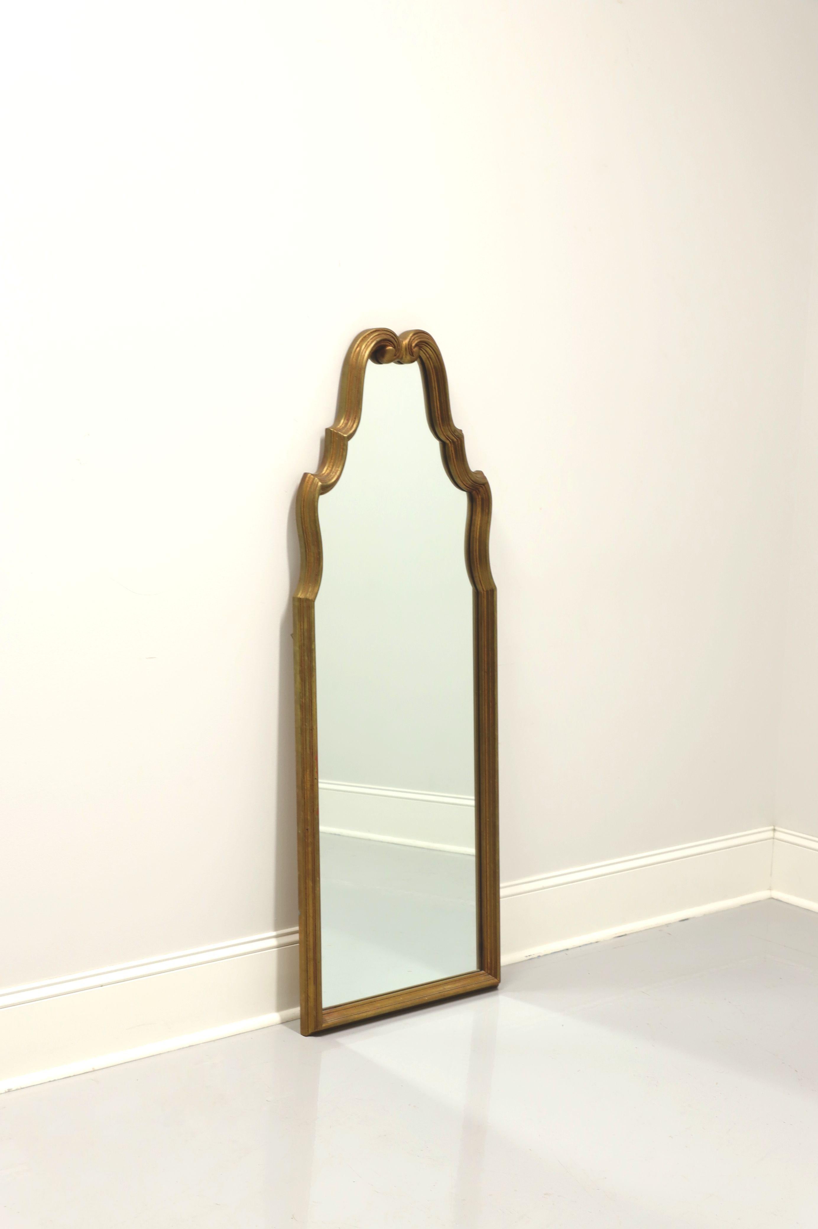 A French Rococo style wall mirror, unbranded. Mirror glass and gold painted wood frame with decoratively carved top and slender profile. Made in the USA, in the mid-20th Century.

Measures: 20.5 W 2 D 56.5 H, Weighs Approximately: 30