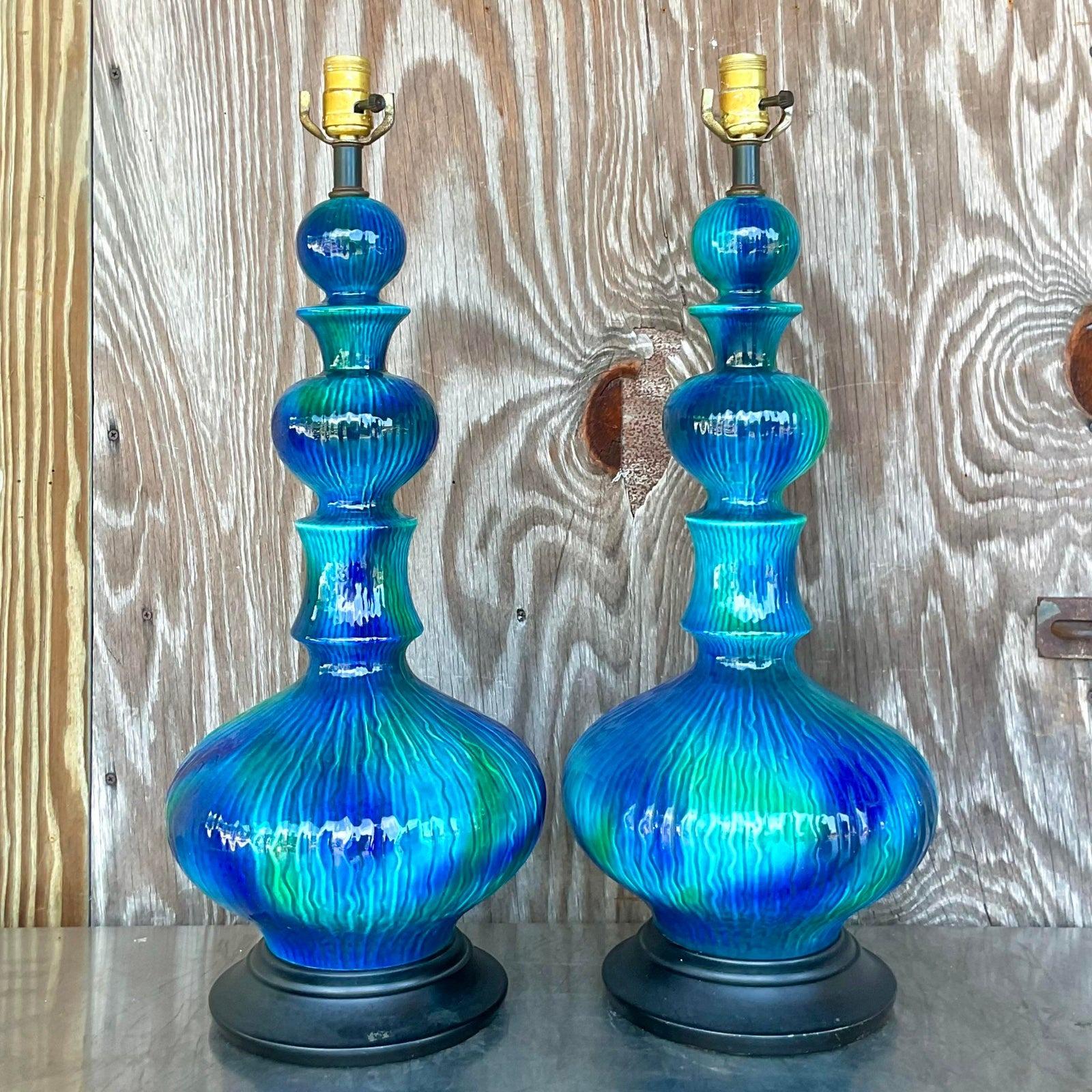 An extraordinary pair of vintage MCM table lamps. A glazed ceramic finish in a brilliant blue green combo. Acquired from a Ft Lauderdale estate.