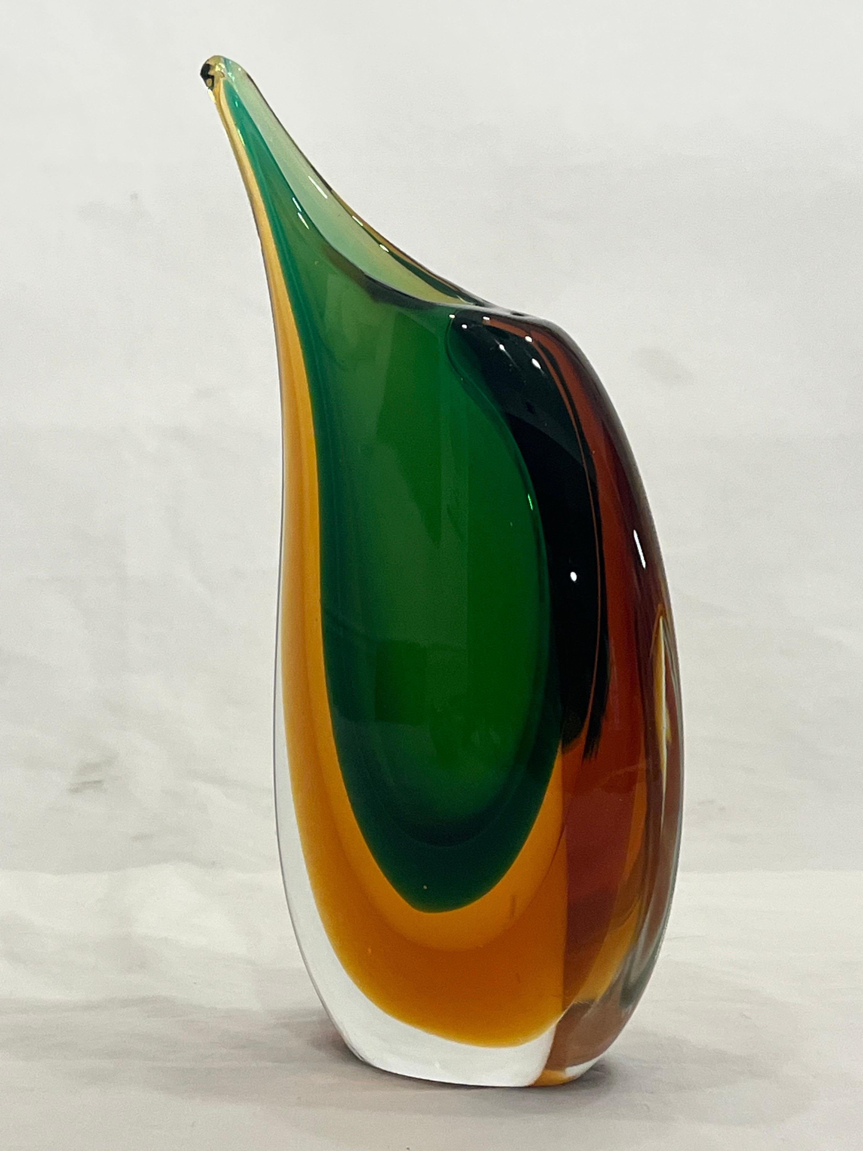 A beautiful green and amber mid 20th century Italian Murano Venetian Sommerso style vase. This vase has a partial label on the bottom. The term Sommerso comes from the Italian for submerged. From the 20th Century Glass website, 