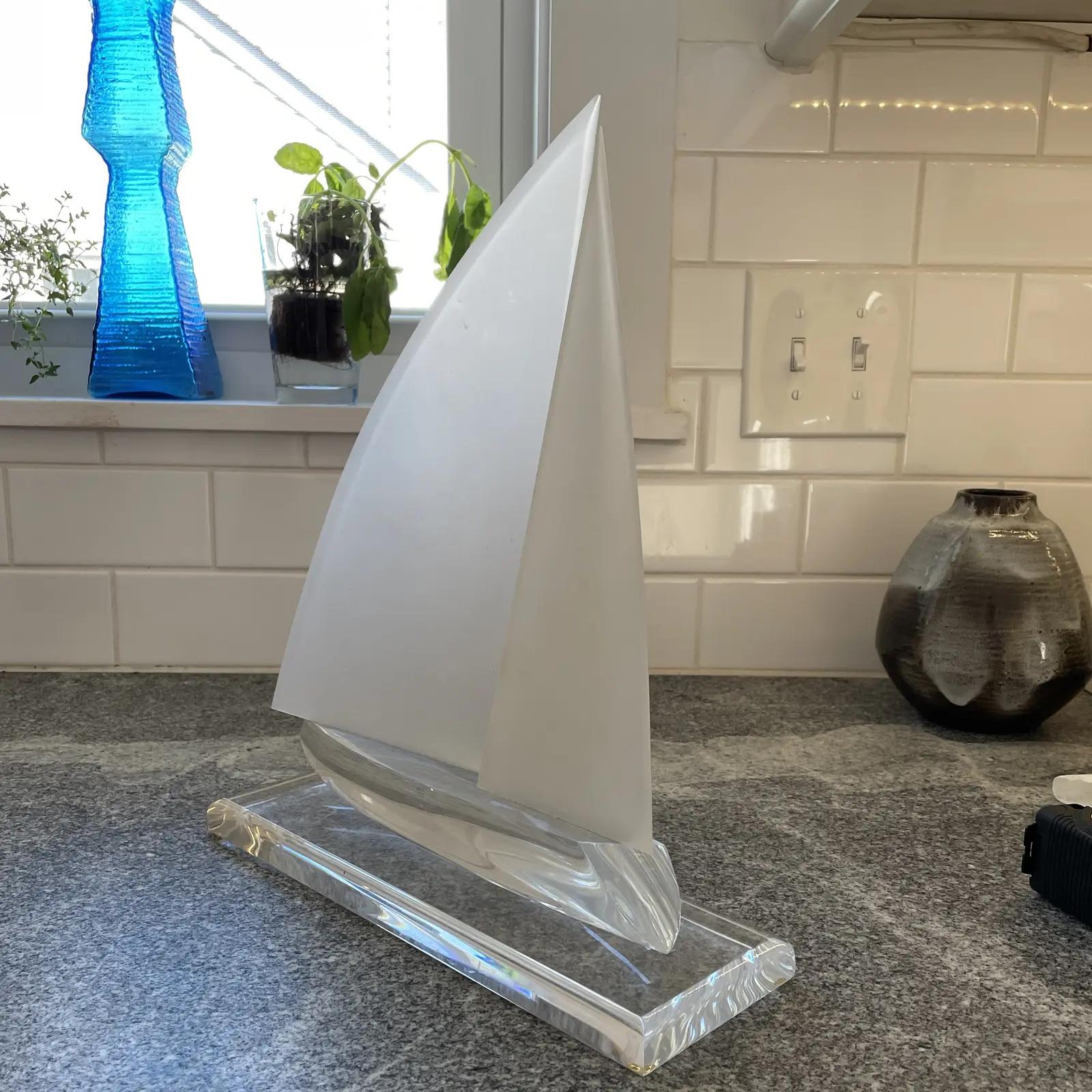 Unique frosted and clear Lucite sculpture of sailboat underway. Wonderful inviting movement as boat is heeling to one side.