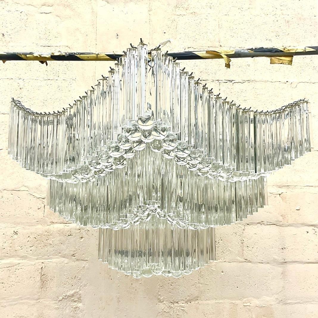 An exceptional vintage Regency chandelier. Monumental in size and drama. After the venerable Venini group. Heavy crystal rods and ball pendants. Just breathtaking. Rods hook on to a metal frame. Easy to move and install. Acquired from a Palm Beach