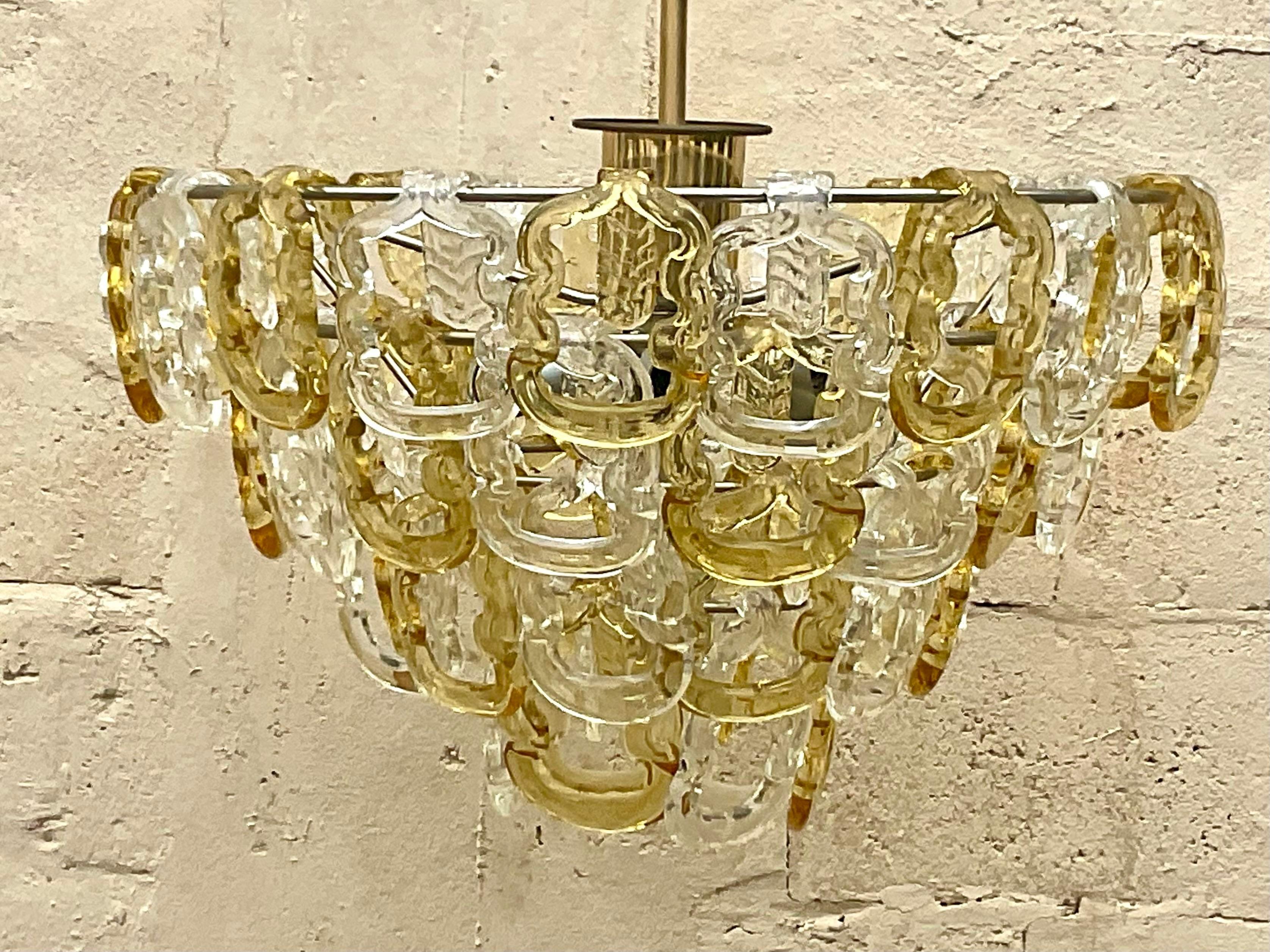 A stunning vintage Regency chandelier. A chic Italian fixture with gorgeous two color Murano glass rings. Acquired from a Palm Beach estate. 