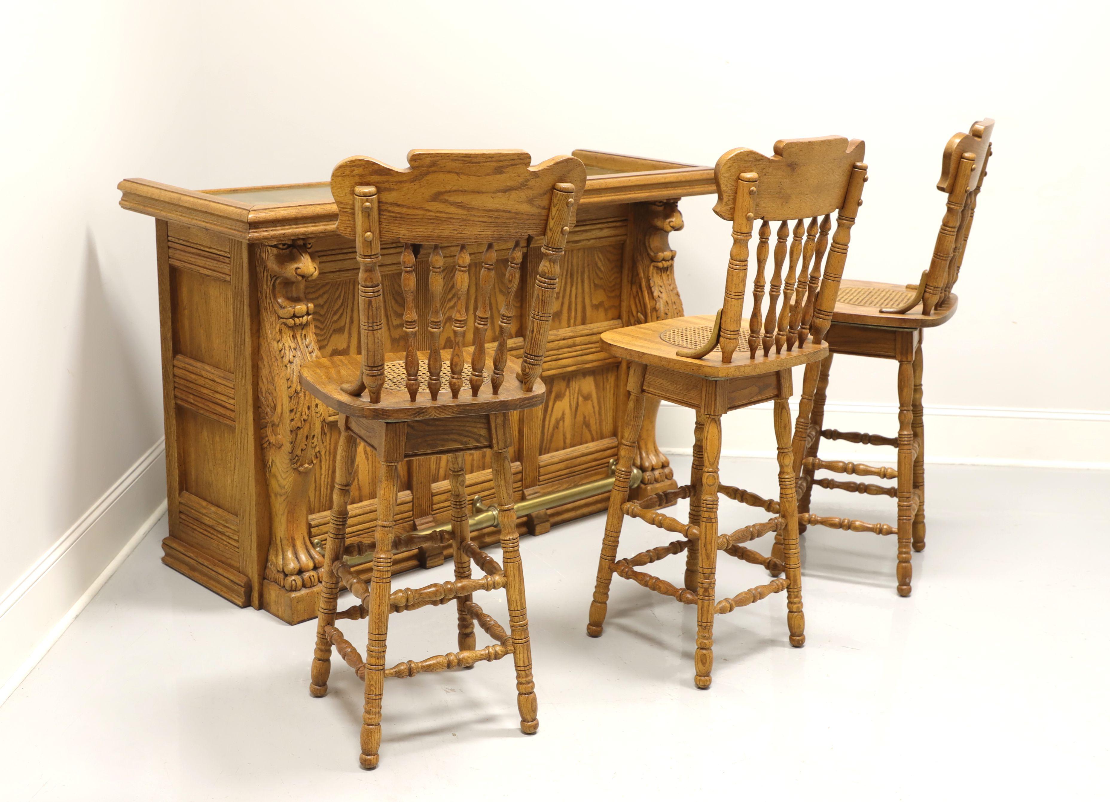 A bar set, bar and three barstools, in the Country Farmhouse style, unbranded. Bar is solid oak with decoratively carved lion columns on either end, carved panels to front & sides, and brass foot rail on the front side. The back side is open with