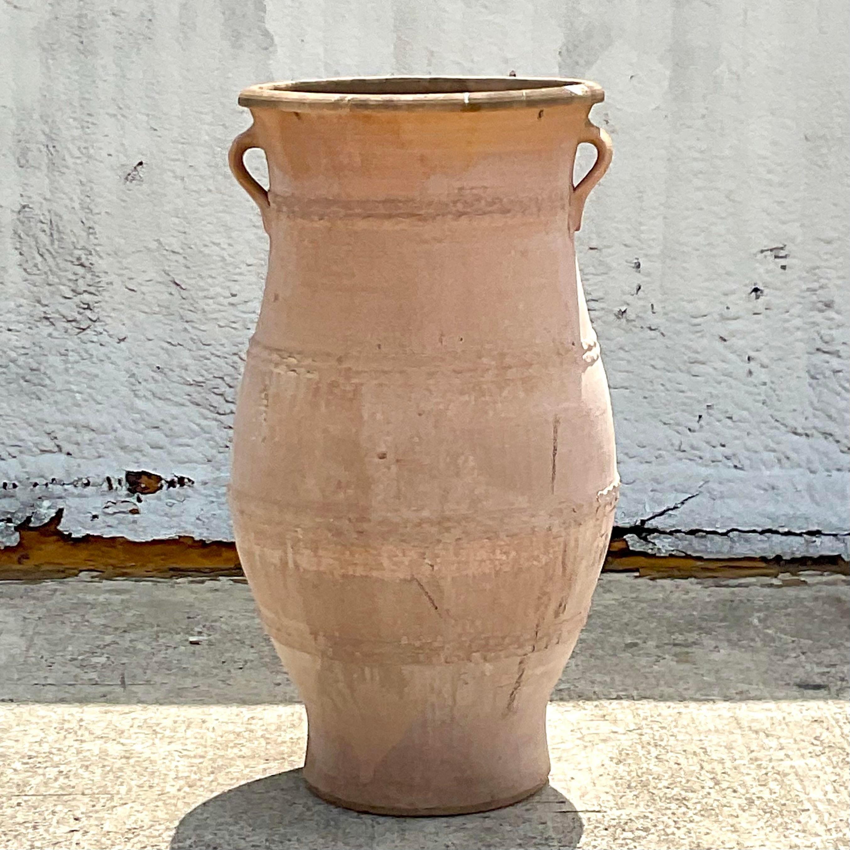 A fabulous monumental terracotta olive jar planters that can add to your outdoor decor. Acquired at a Palm beach estate.