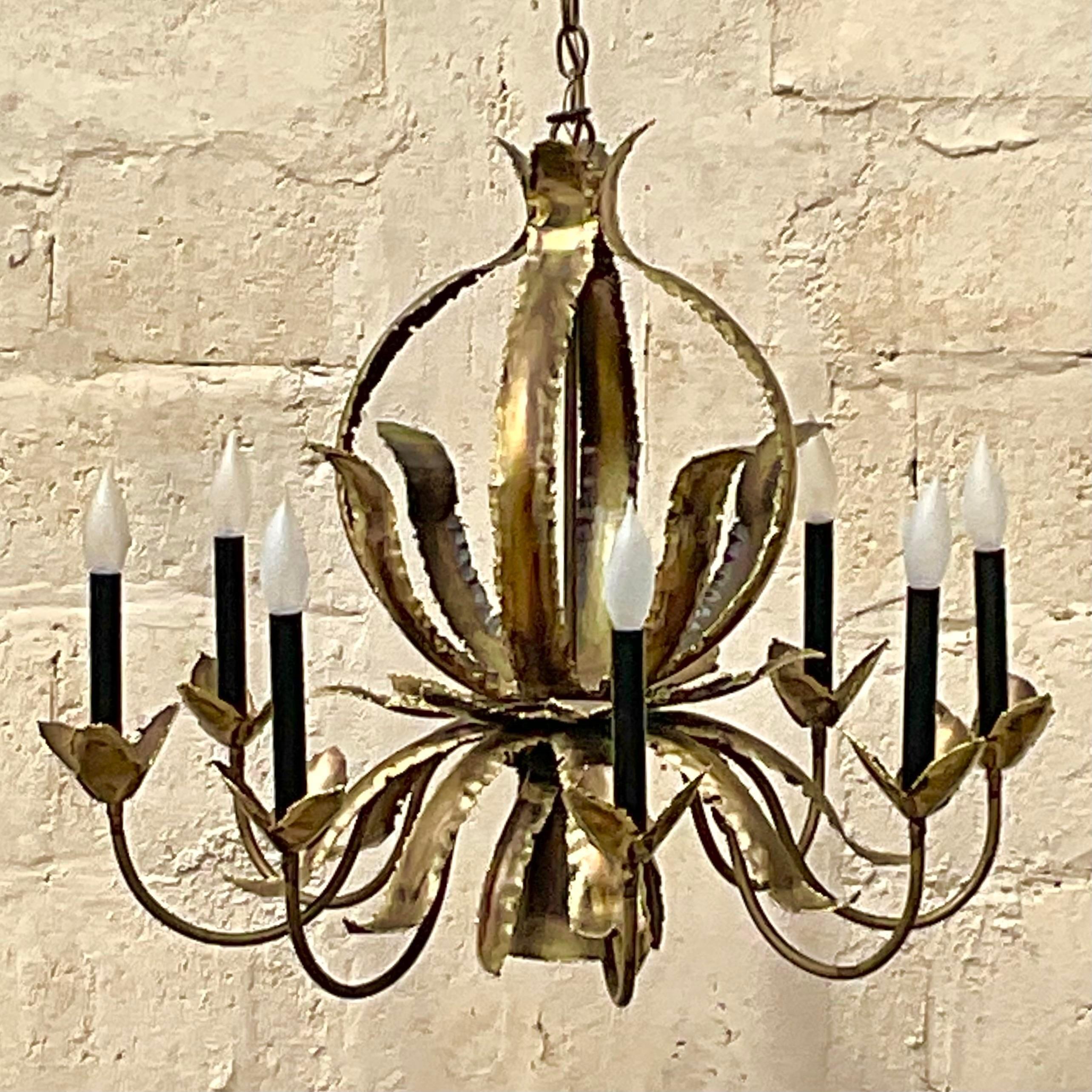 A fabulous vintage MCM chandelier. Designed by the iconic Tom Green for Feldman. Togged on the ceiling plate. Beautiful torch cut leaves with 8 arms. Acquired from a Palm Beach estate.