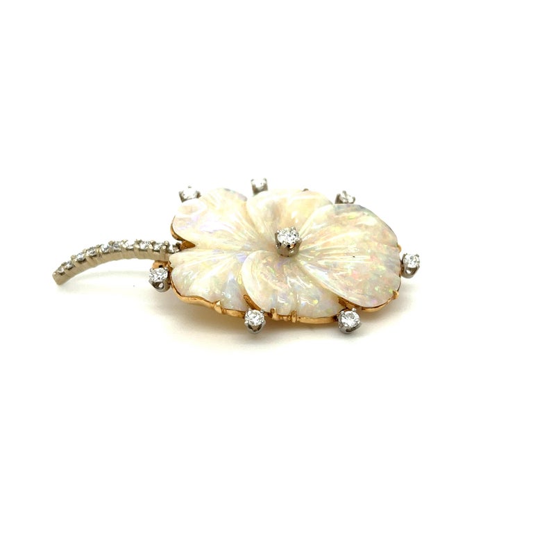 An usual vintage carved opal pansy brooch set with diamond, circa 1960. This beautifully rendered opal is carved in a Pansy flower shape. Pansies have tremendous meaning in jewelry symbolism - often given as a love token reminding the recipient to