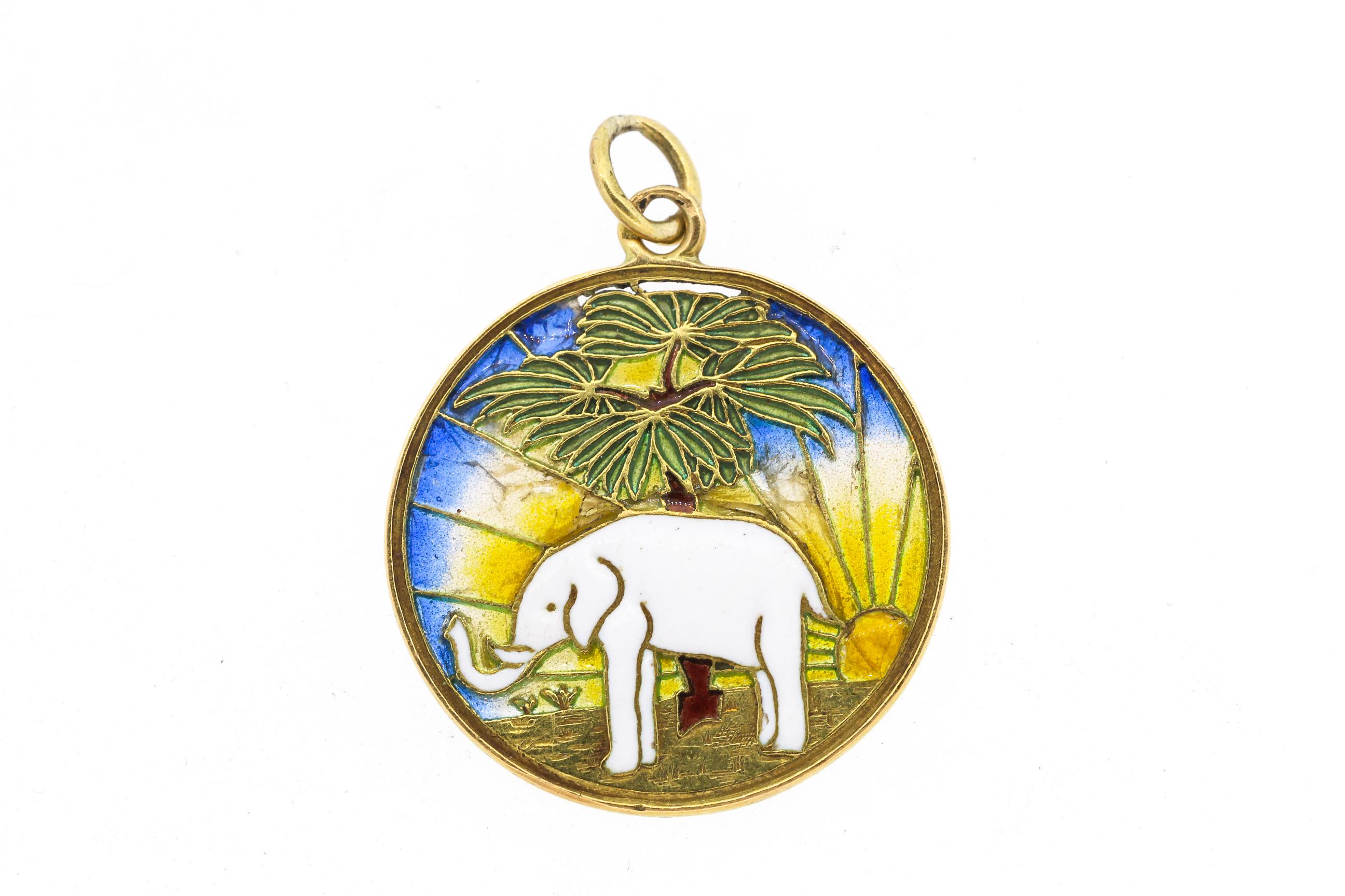 A charming vintage 18k yellow gold and enamel elephant charm with colorful plique-a-jour background circa 1950. The charm has French hallmarks. The elephant has its trunk held up which is a symbol of good luck. The charm is double sided, so the