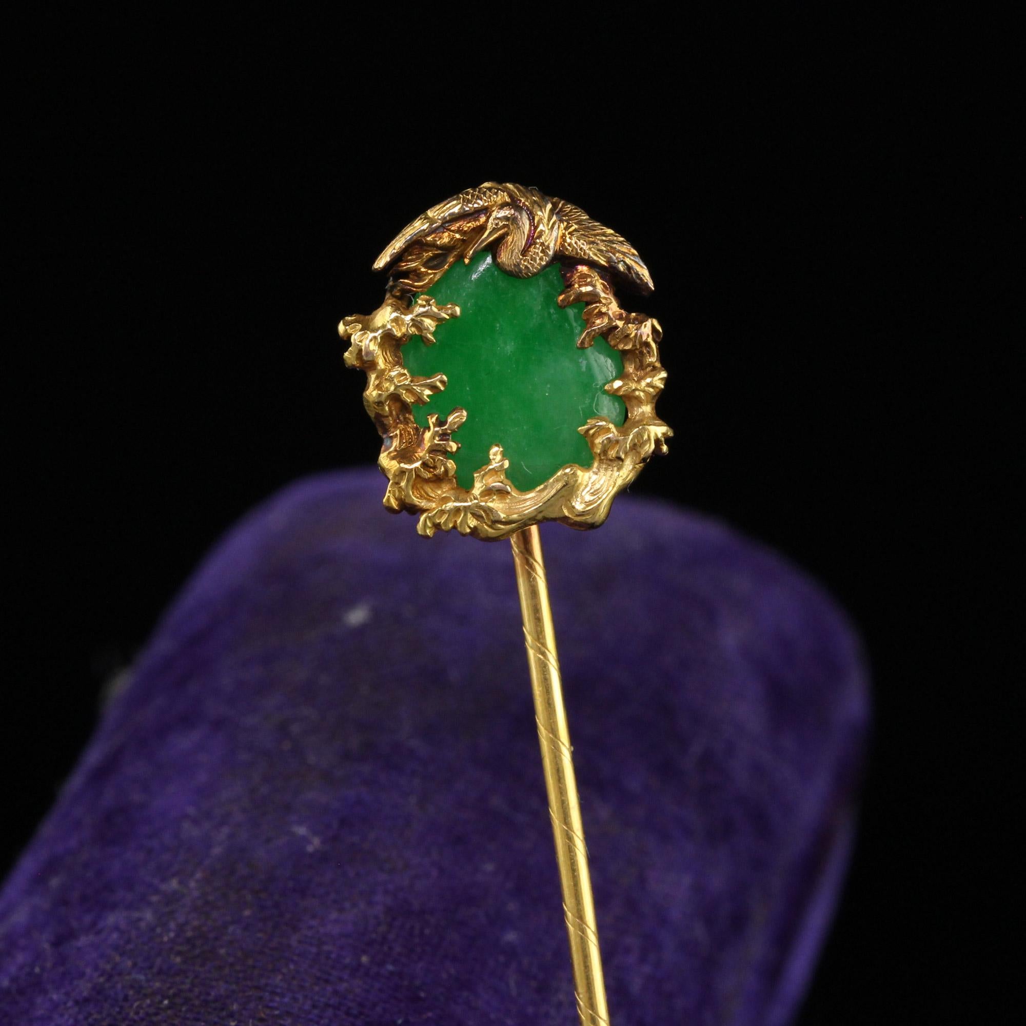 Beautiful Vintage Mid Century 18K Yellow Gold Natural Jade Crane Stick Pin. This gorgeous jade stick pin is crafted in 18k yellow gold. The center of the pin holds a natural green jade. The depicted scene is of a Crane bird sitting on top of the