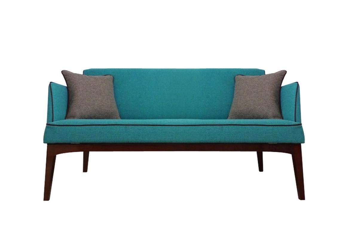 This is a clever little vintage midcentury Danish sofa that is both a comfortable sofa and also a day/overnight bed. It features fold down arms and a removable back that allows bedding to be stored in the actual sofa back itself. Sheathed in satin