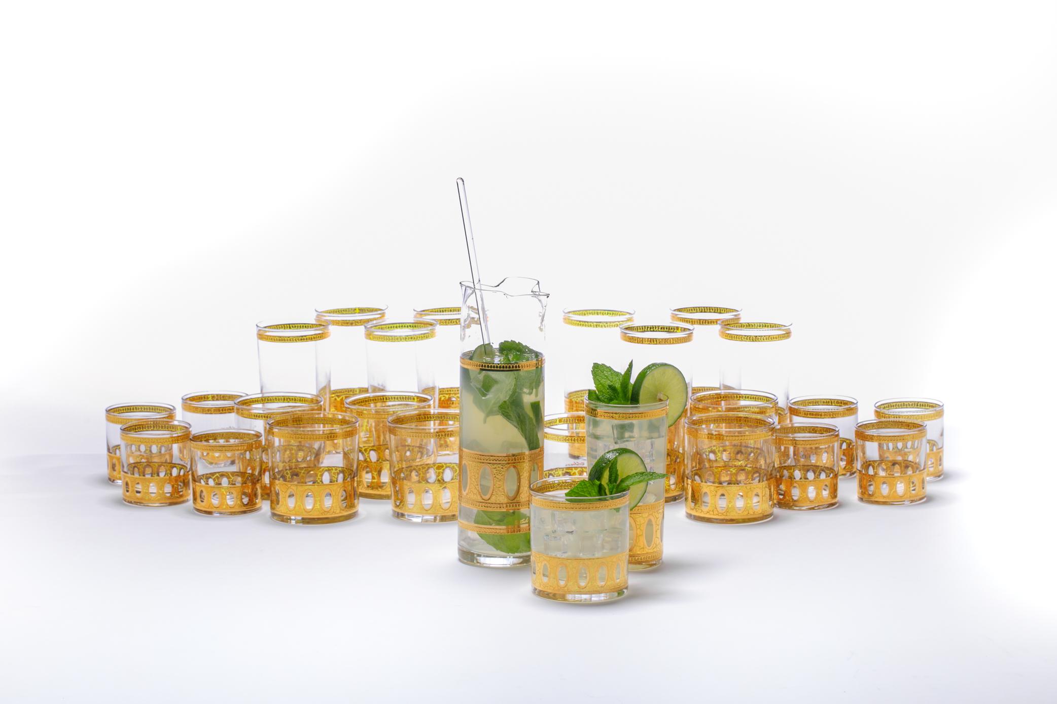 Dress your cocktails in high style with these beautiful tall highball cocktail glasses in mint condition. This Mid Century Modern set dates back to the 1960s - dressing up sexy bars for decades - and features an elegant 22-karat gold plated MCM