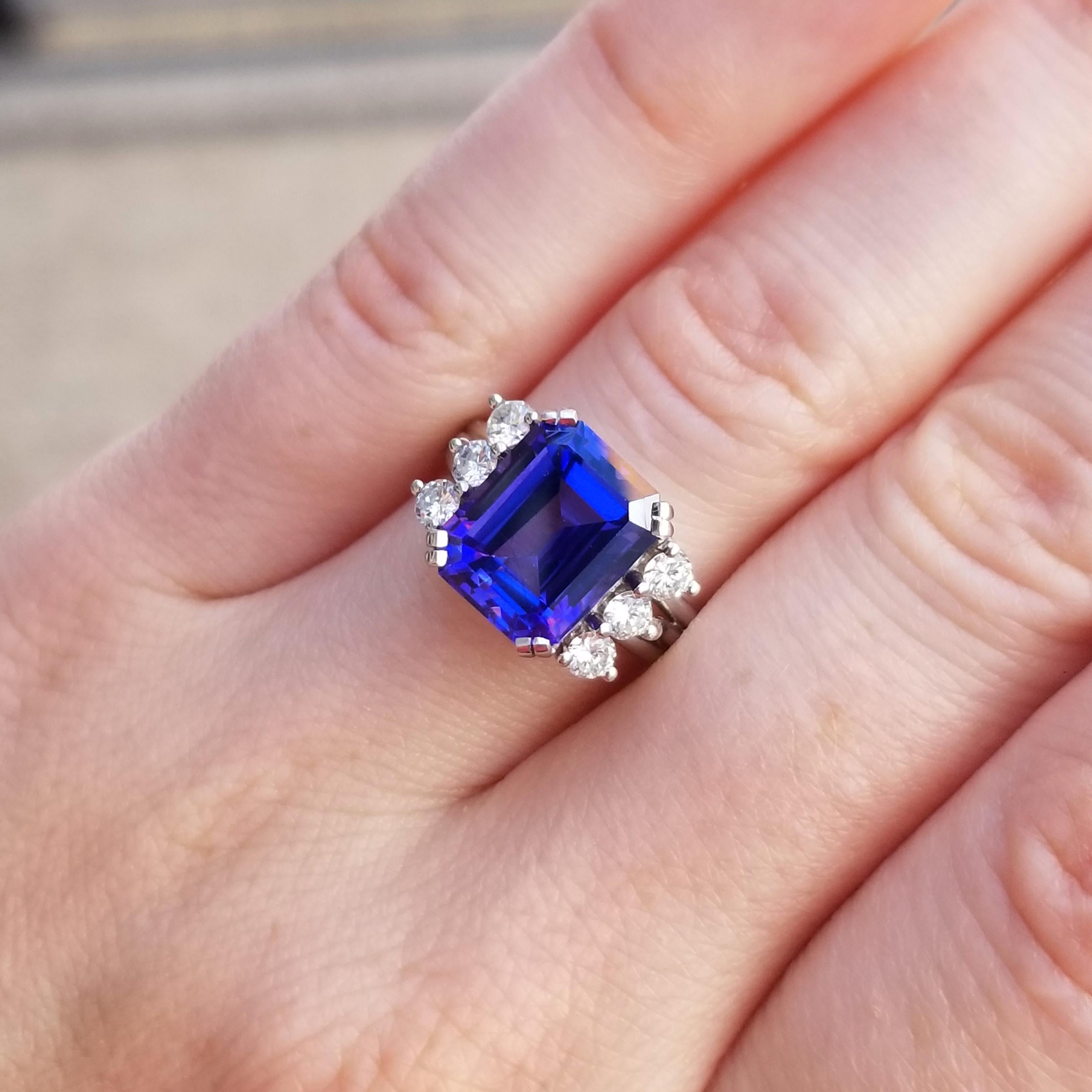 This custom made platinum and diamond ring is a timeless frame for this gorgeous 4.85ct tanzanite. The beautifully cut gemstone shows blue, purple, and flashes of red.

What is especially interesting is that the gem was purchased from a dealer in