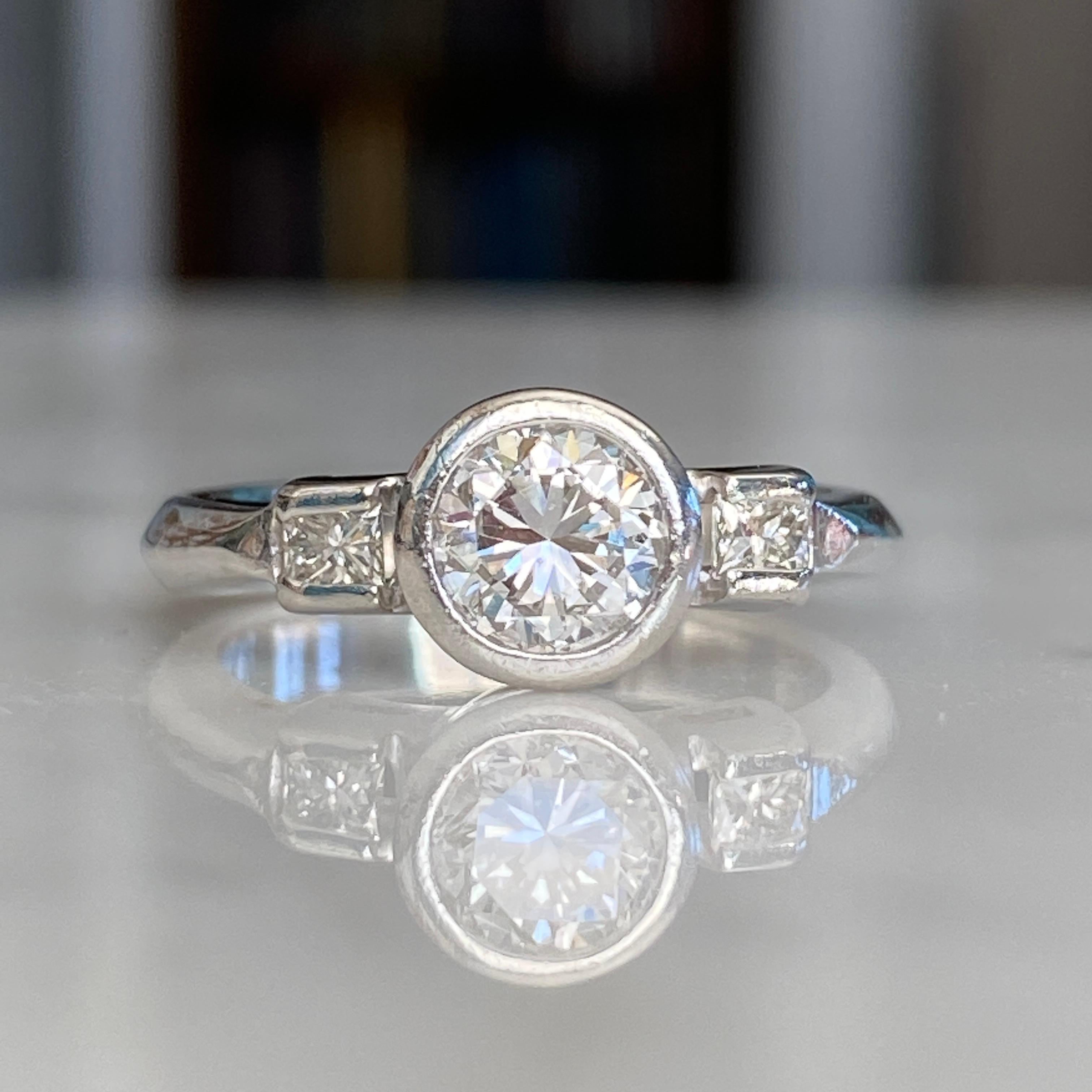 Details:
Modern vintage with a sweet heart carved into the side of this Mid-Century 1940's Platinum Diamond ring. This ring has a round brilliant cut measuring .83cts, with a combined total weight of just under one carat—.98 carats. A classic, and