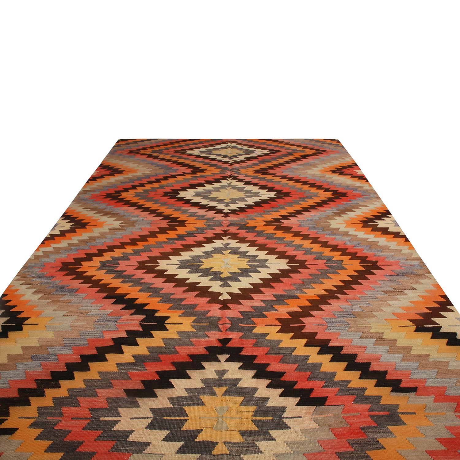 Flat-woven in Turkey originating between 1950-1960, this vintage midcentury tribal Kilim hails from the province of Afyon, celebrating a very idyllic but lively approach to tribal colorway with hues of orange, yellow, pink, black, blue, and beige in