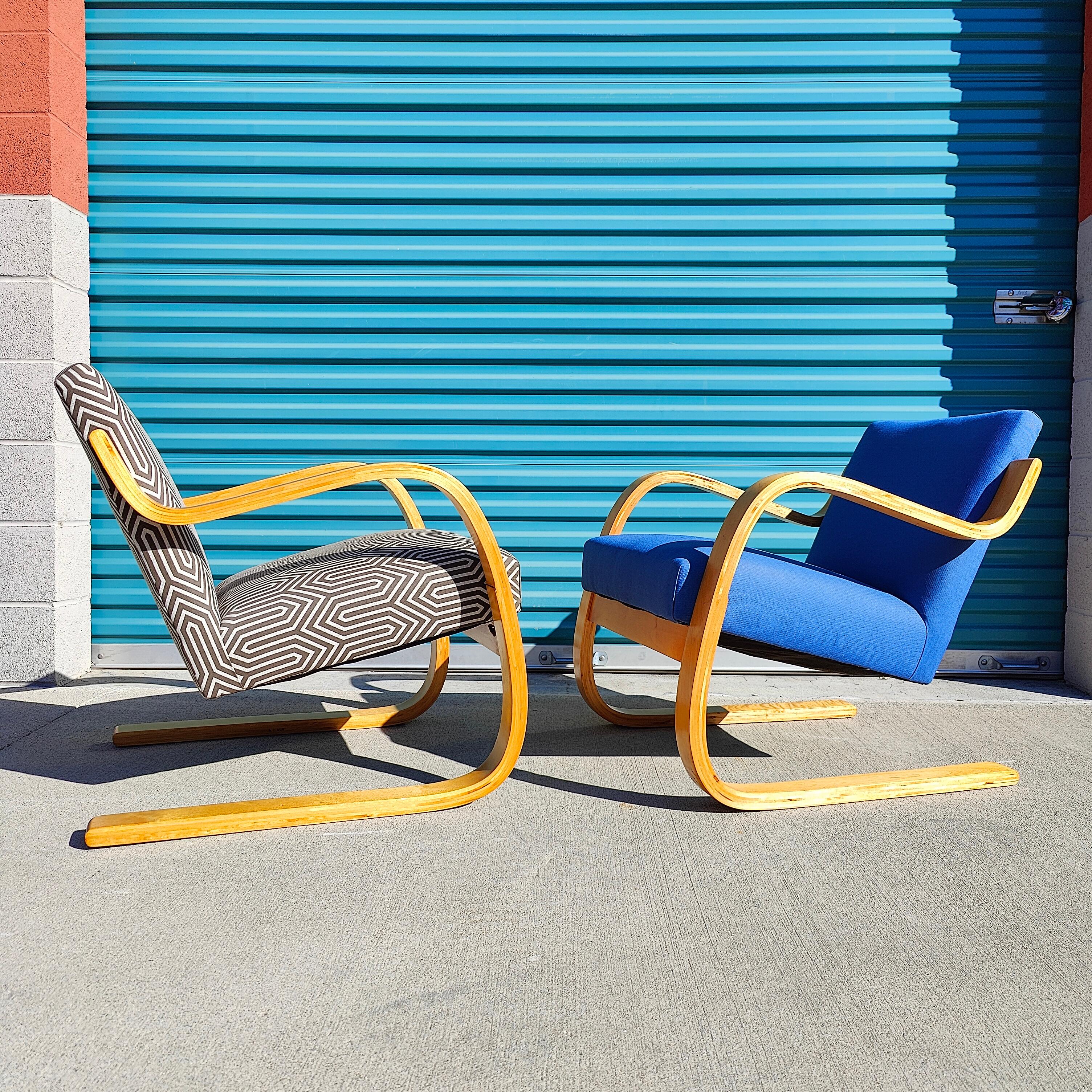 Now available is a pair of Alvar Aalto cantilever lounge chairs model 402 for Artek. These chairs feature birch bentwood frames that have been reupholstered at one point in their lives. Frames are in great unrestored condition. Each chair measures