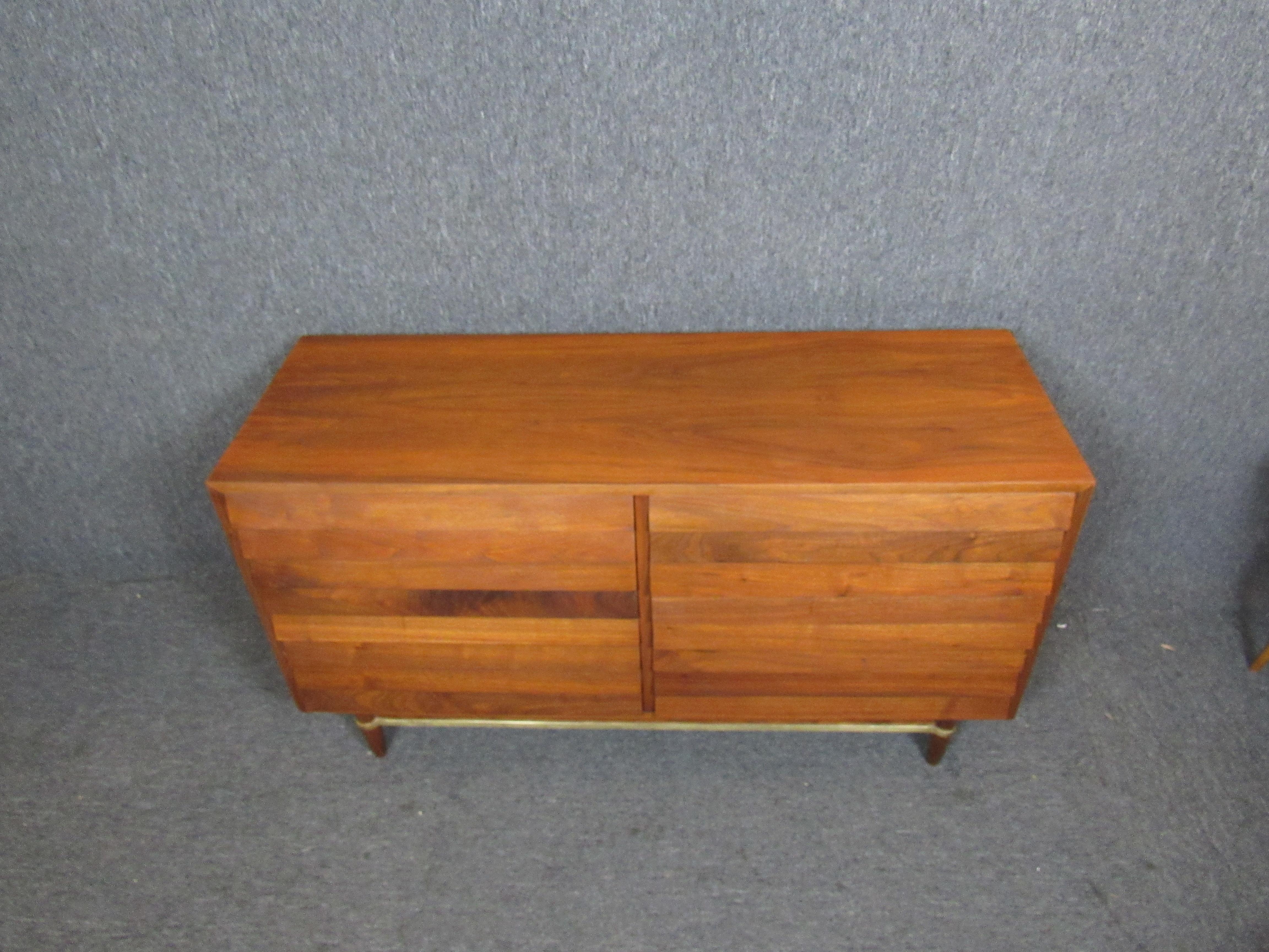 Absolutely stunning mid-century dresser made by the American of Martinsville of Virginia. Six large, louvered pull-out drawers provide ample storage for the bedroom, living room, or office. Brass accents highlight beautiful carved legs, and a newly