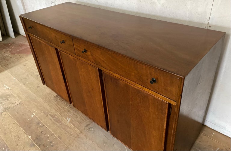 Mid-Century Modern American of Martinsville 2 drawer, 3 door credenza in warm walnut wood cabinet.  Original vintage condition.  A great entry way piece, office credenza, or use as buffet server in a dining room. 
