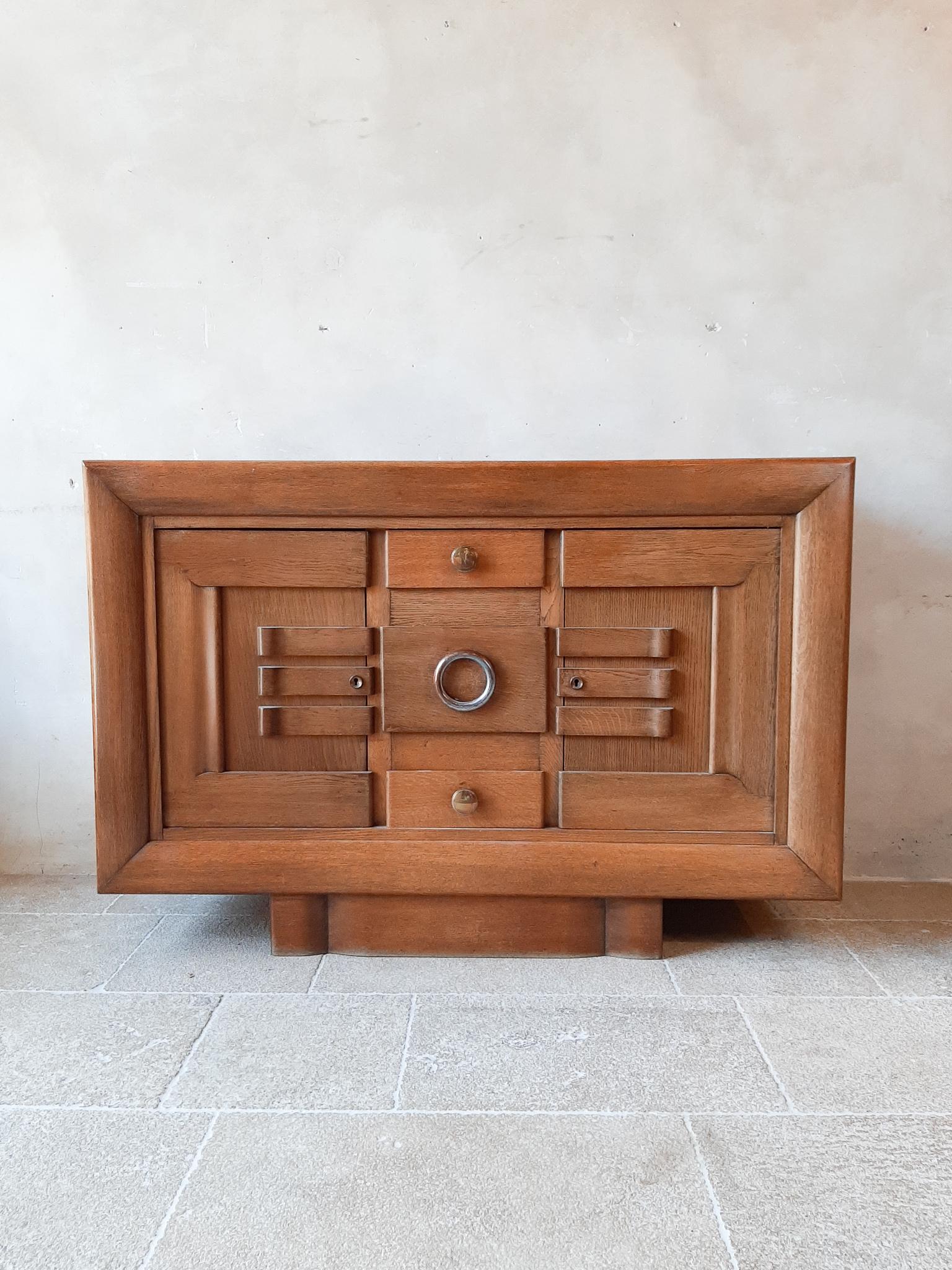 Midcentury sideboard, credenza by Charles Dudouyt in blond oak, vintage design 1930s. The cabinet features 2 large doors on each side, and 3 draers in the middle. The doors and drawers have a stunning Art-Deco design, and show great craftmanship.