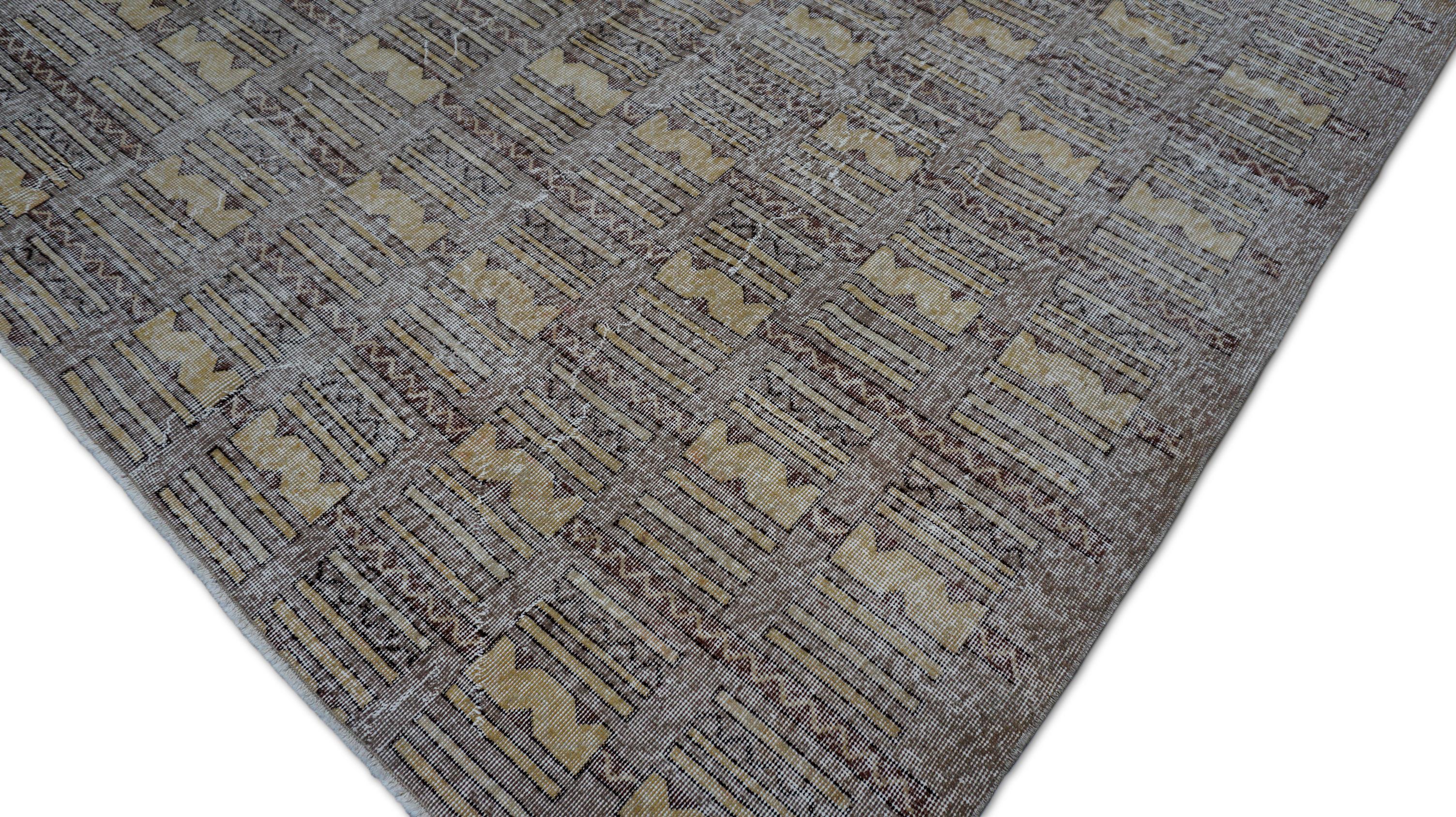 Ce tapis en laine noué à la main présente un saisissant motif tribal en grille, se répétant en symétrie rythmique à travers le champ. Chaque compartiment est orné de motifs géométriques, inspirés des tissages des villages anatoliens, dans des tons