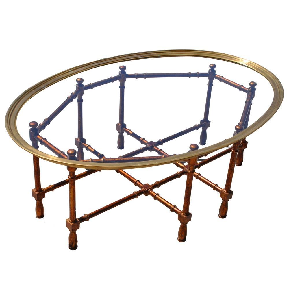 Vintage midcentury Baker faux bamboo brass coffee table 

Painted and lacquered with a faux tortoiseshell finish in gold and bronzes. Features an oval-shaped removable brass and glass top.
 