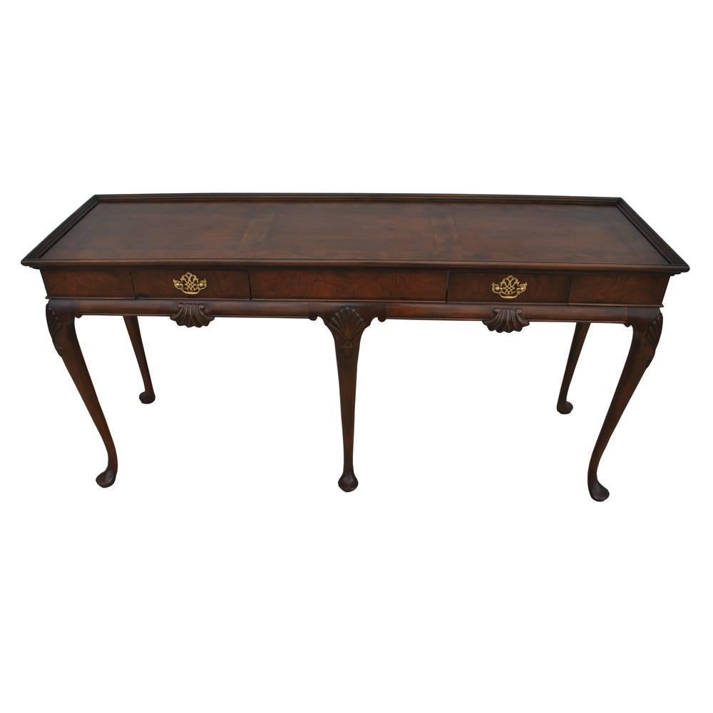 Baker
 
Vintage midcentury Queen Anne style console
 
Burled walnut
Two drawers with brass pulls
Triple cabriole legs in front.

 