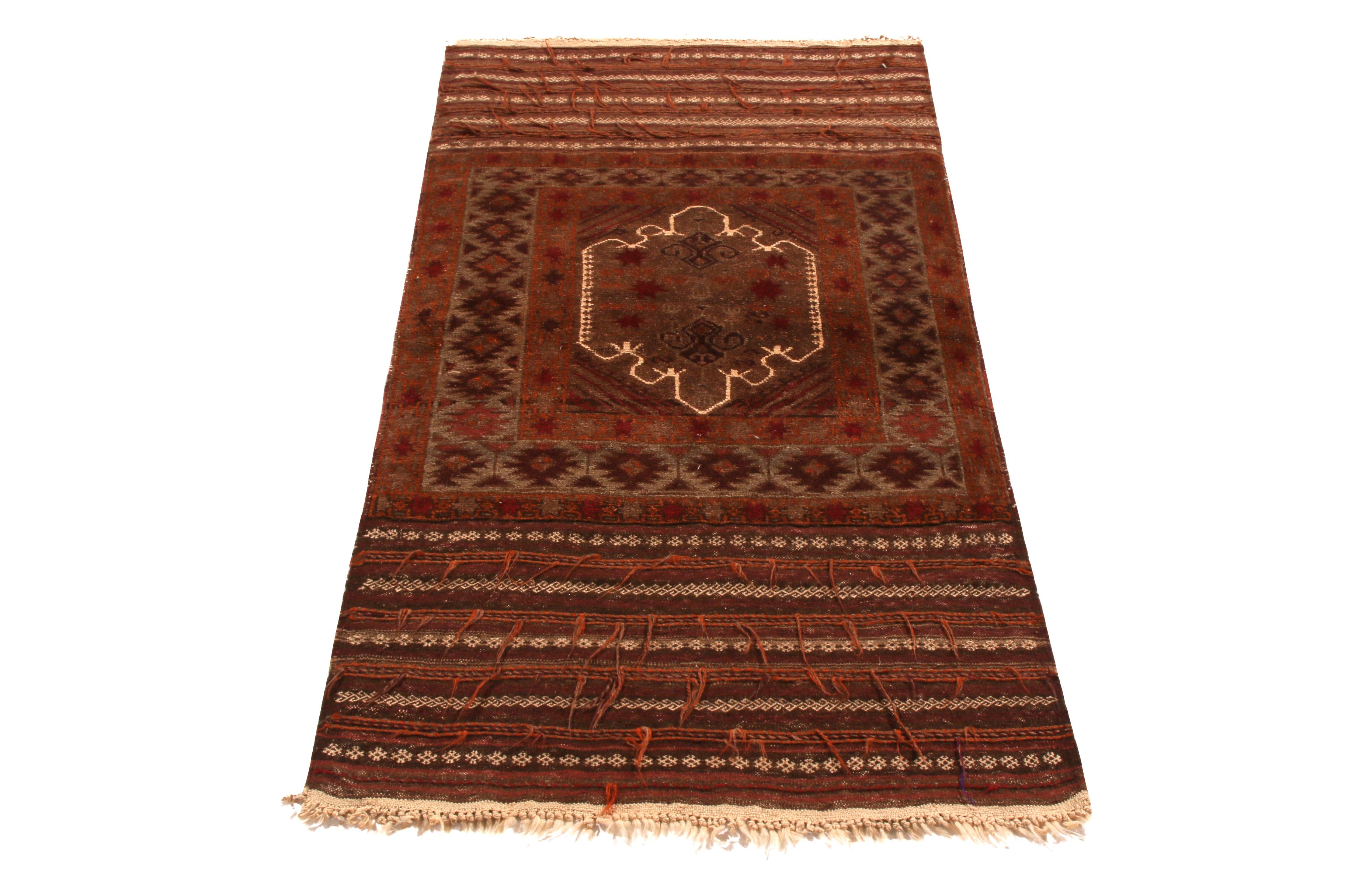Made with hand knotted wool pile originating between 1950-1960, this vintage midcentury Baluch Persian rug employs the subtle juxtaposition of gentle and defined color and pattern in a skillful fashion only the most celebrated finds of the period
