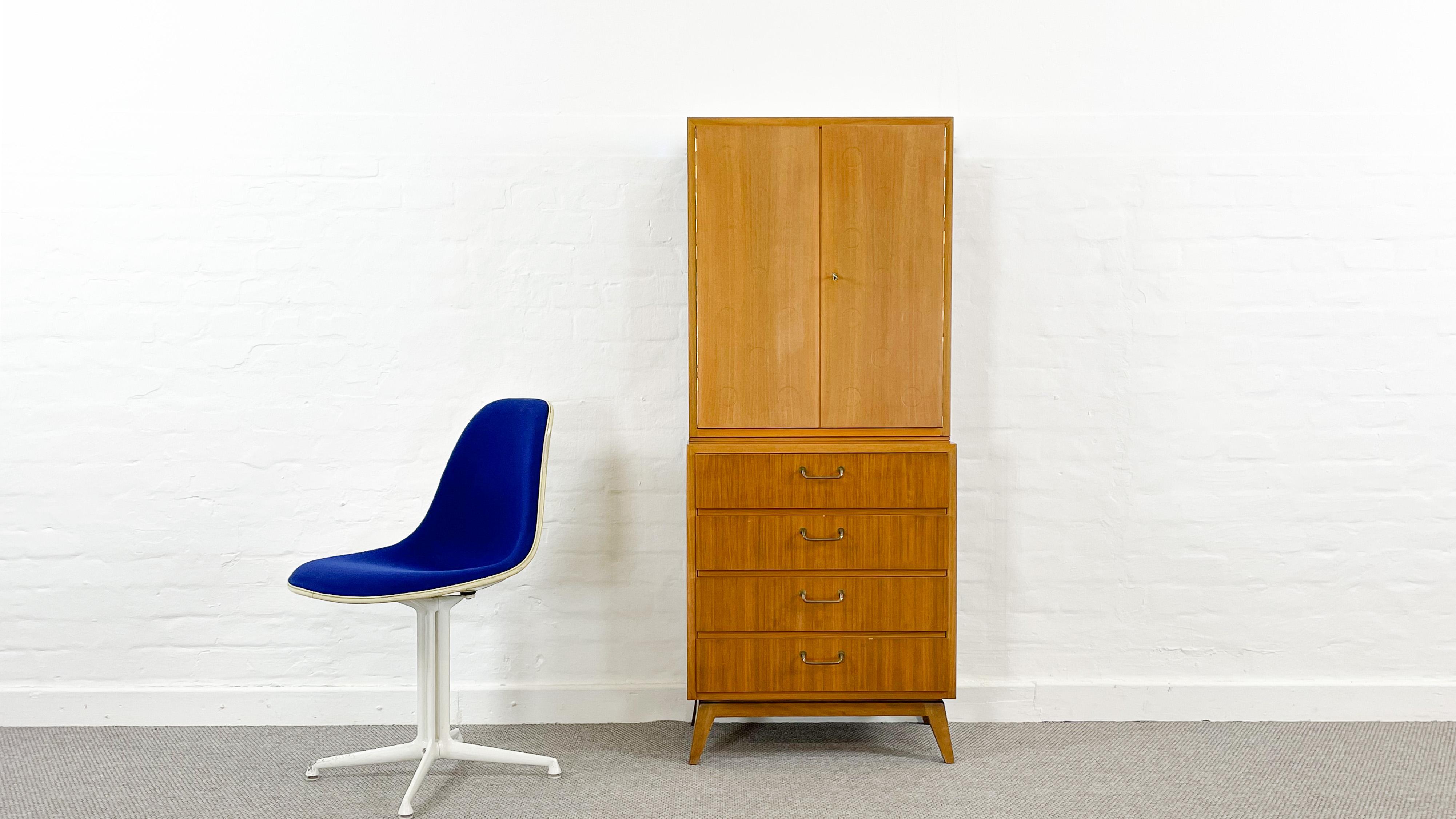 Mid Century two piece bar cabinet consists of chest of drawers and bar cabinet on top in nutwood veneer. Both pieces are stamped on the back with EBW - Ernst Behr. Designed and executed in the 1950s Jahren. Cabinet chest with imprinted decorative