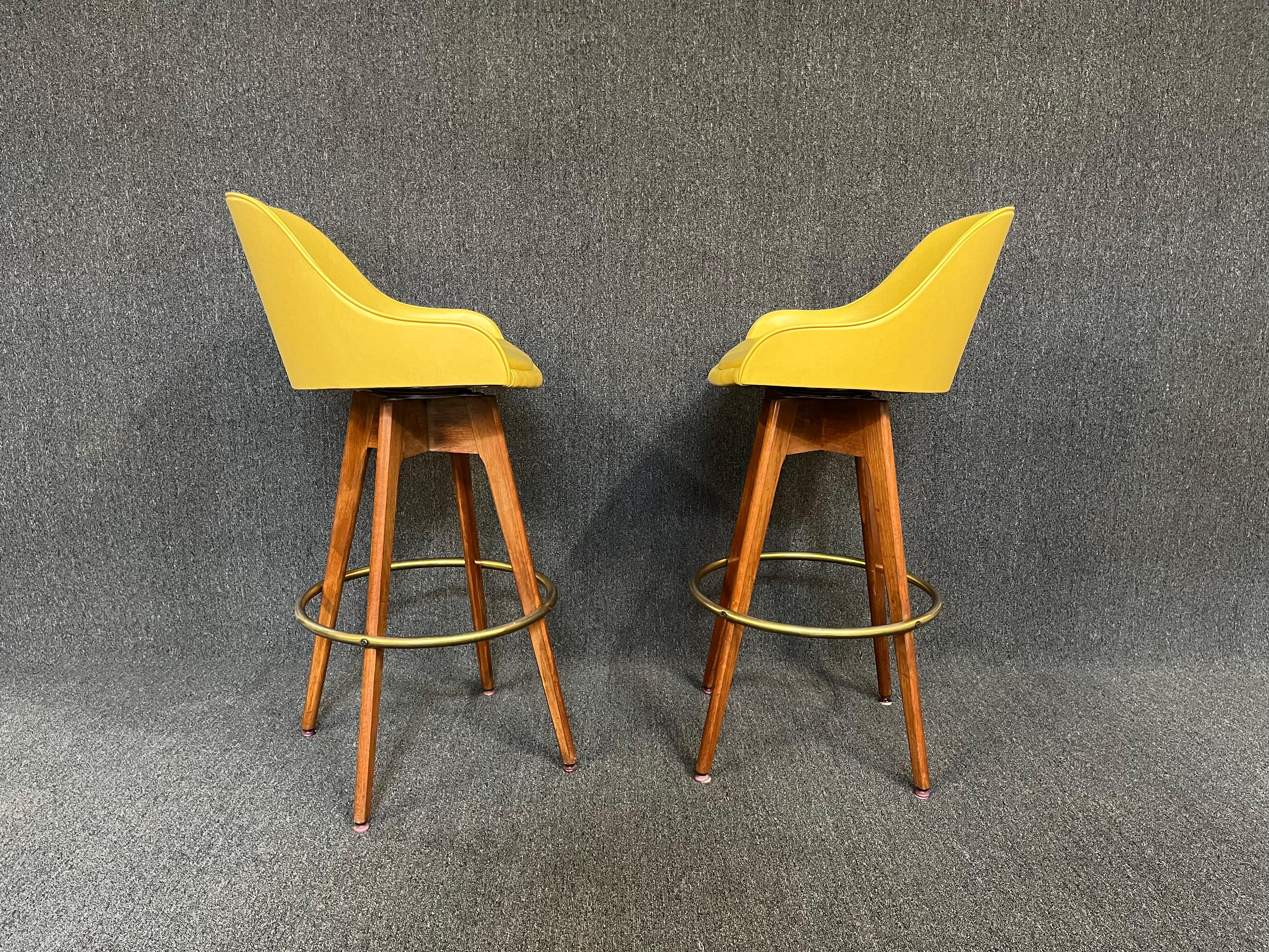 Here is a killer pair of vintage mid century bar stools by Chet Beardsley. Original yellow vinyl fabric is in great vintage condition with minimal wear. Solid black walnut frames are in great condition as well.

These are BAR HEIGHT
