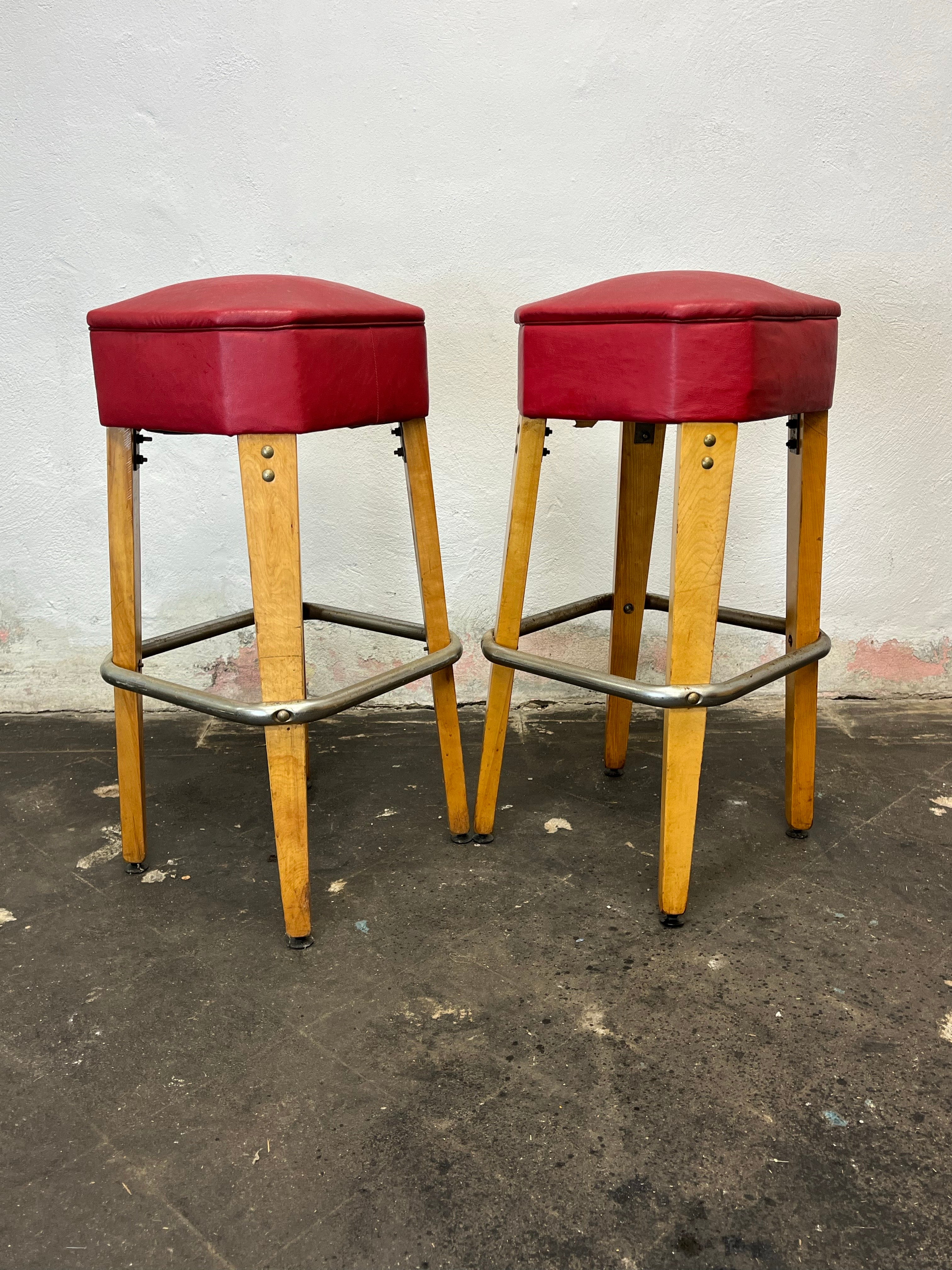 Stunning survivors! Heyward Industries bar stools with tapered knife legs, textured naugahyde seats and steel foot rails. Great period lines, solid and sturdy. 
Curbside to NYC/Philly $450