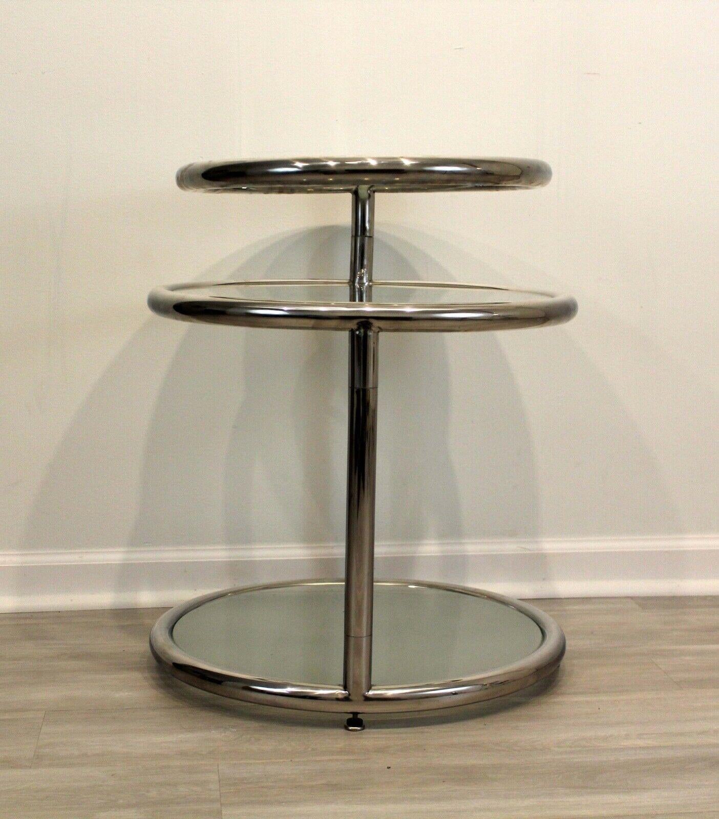 This lovely chrome and glass side table is as functional as it is sophisticated. With 3 tiers that swivel for storage, 

Dimensions: 21 diameter x 25 height.