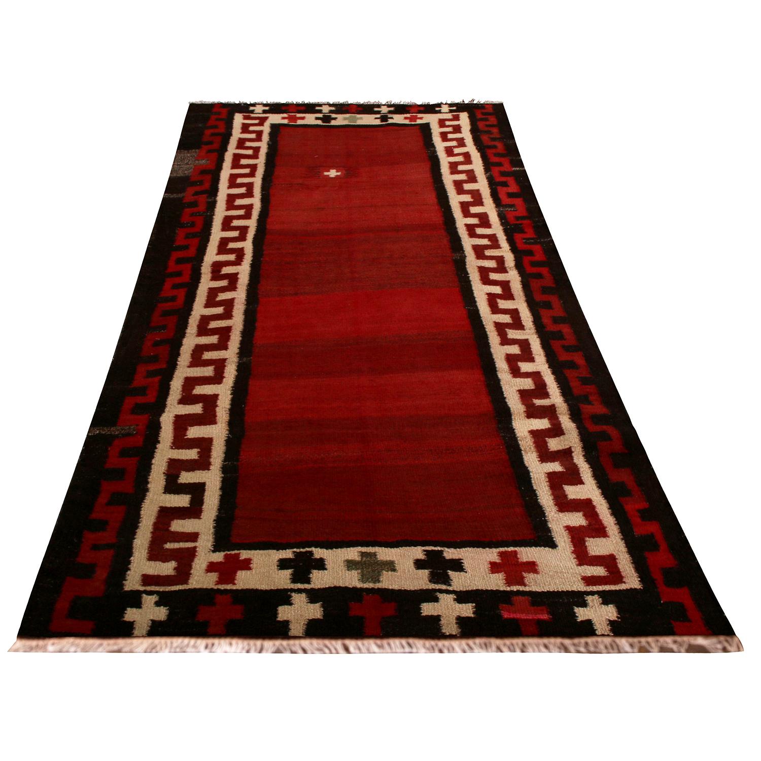 Handwoven in wool originating from Persia between 1950-1960, this vintage midcentury Persian Kilim is a Bidjar (Bijar) rug, named for the titular region celebrated for the quality material, craftsmanship, and durability pieces like this item enjoy.