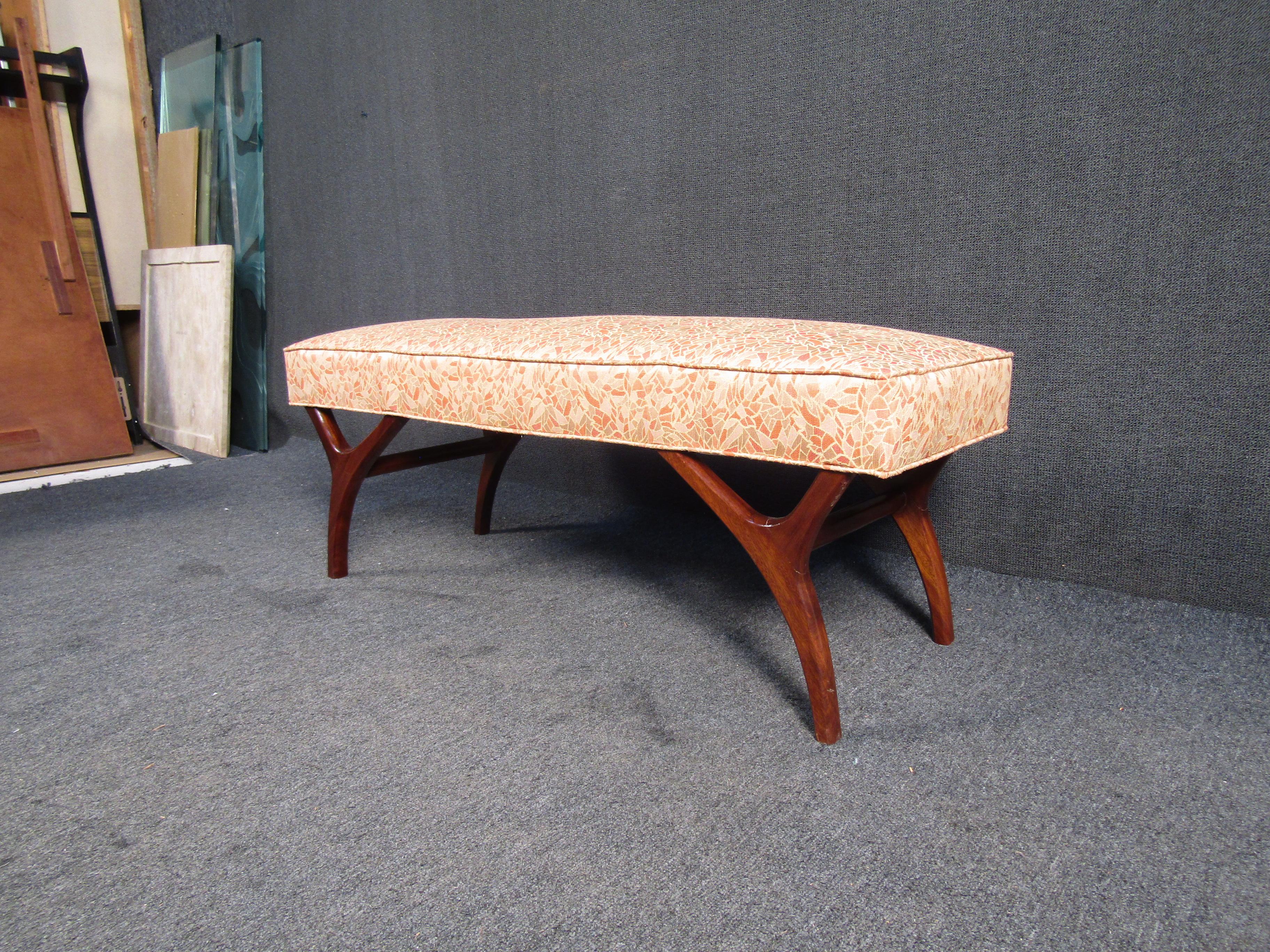 Beautiful Mid Century side bench with Wooden Legs. This bench features a unique floral pattern seat and finished wooden legs. This would make a great addition to any space needing some extra seating.

Please confirm item location - NY or NJ - with