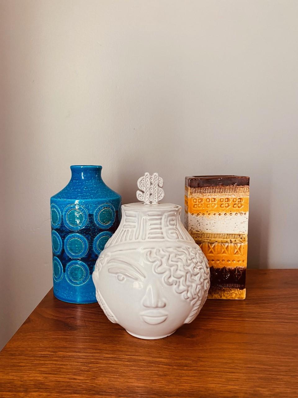 Incredibly iconic piece of pottery.  The allure of this piece transports you to the Italian coast decades past. This beautiful vase is sculptural and unique.The vase features a circle design on a vibrant blue background with slightly green centers