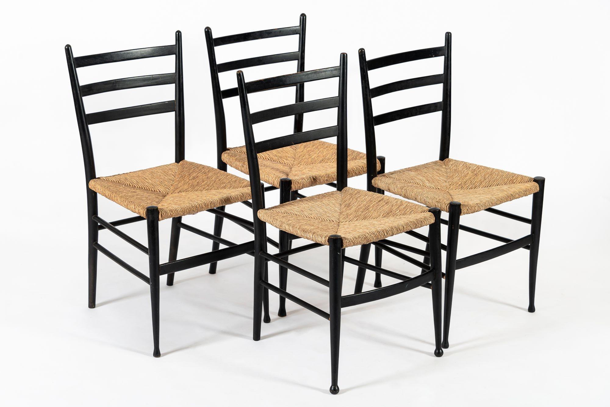 This set of four vintage mid century modern side chairs made in Italy circa 1960 are in the style of the Leggera chair by renowned mid century modern Italian designer Gio Ponti. The classic and elegant design features black solid wood frames with