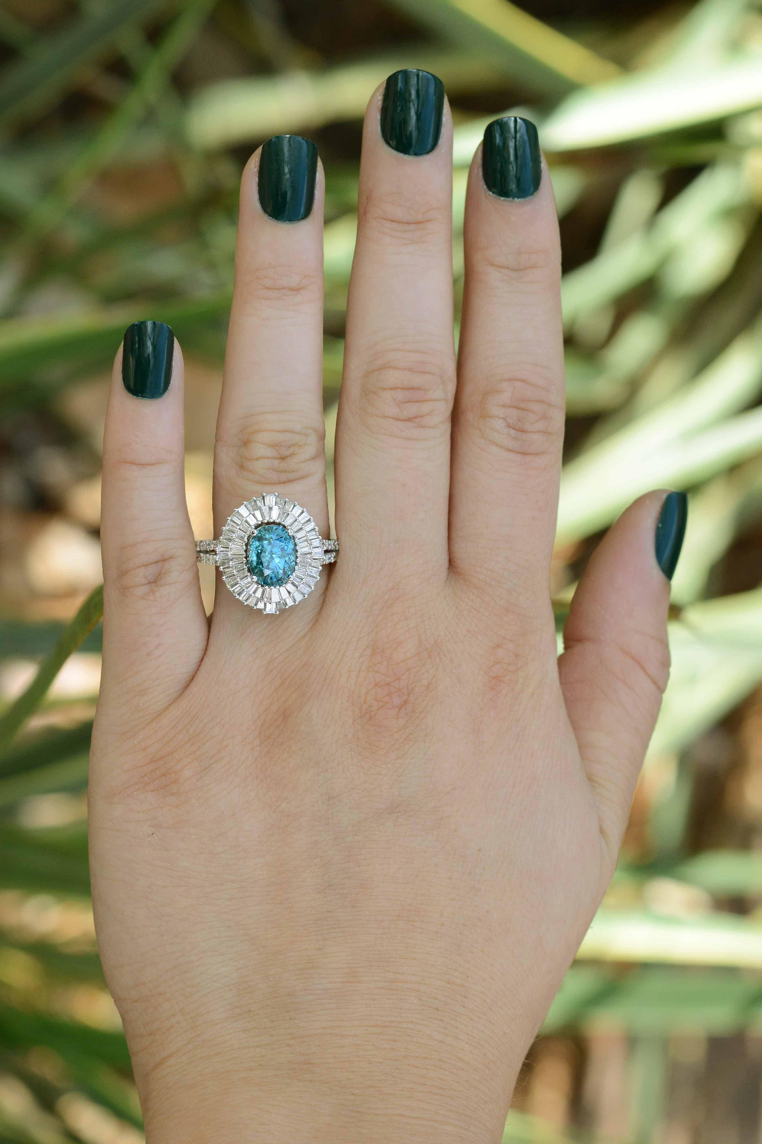 This is without a doubt a show-stopping Mid Century modern ballerina ring. The vivid, intense blue zircon gemstone is the focal point of this glamorous statement jewelry piece is of considerable size at 5.24 carats. Along with 58 baguette diamonds