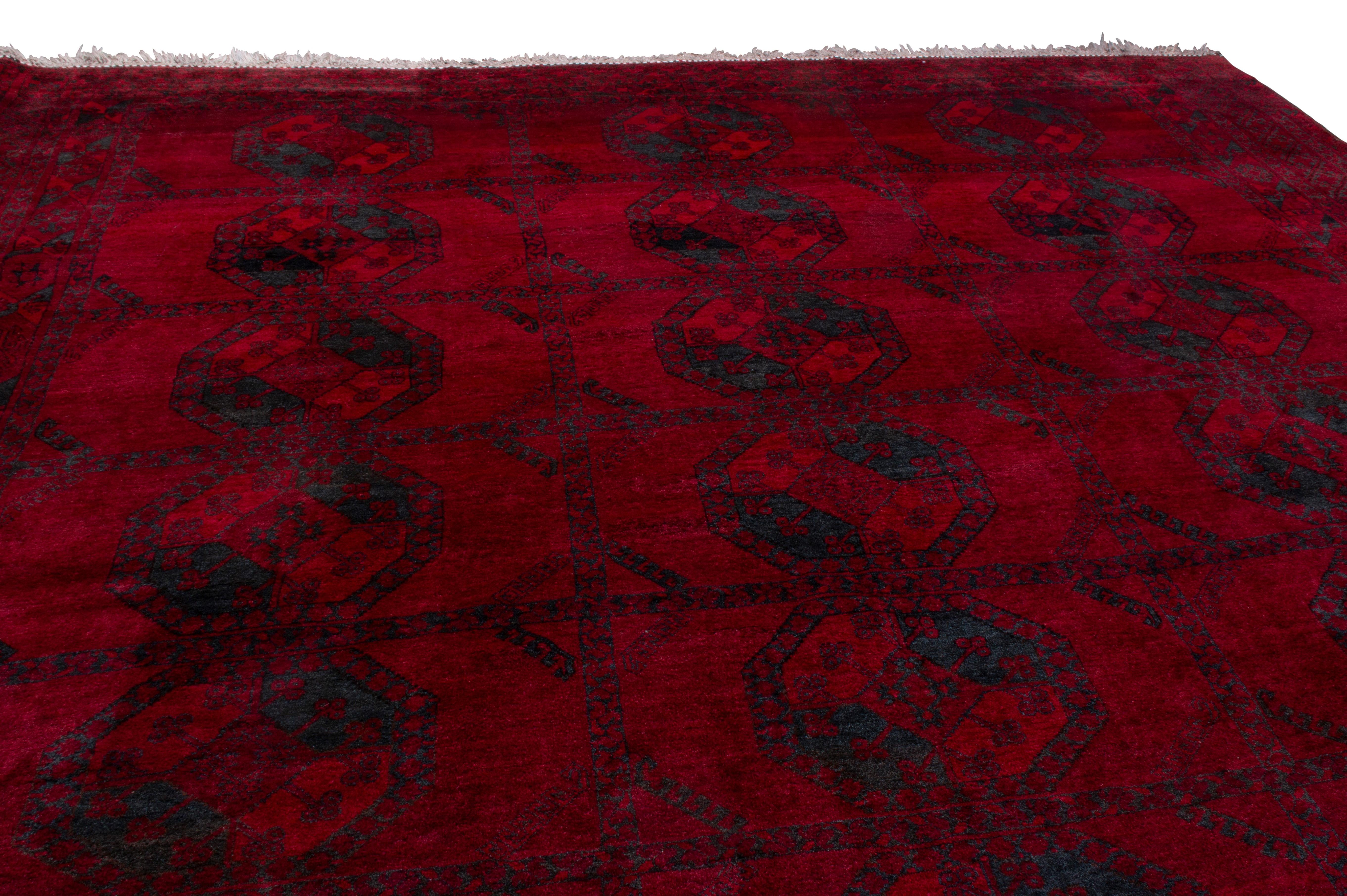Originating from Afghanistan in 1950, hand knotted in durable, high-quality wool, this more modern Afghan piece enjoys a more finely woven pattern than even its renowned antique ancestors, though it still employs bold color contrast with the